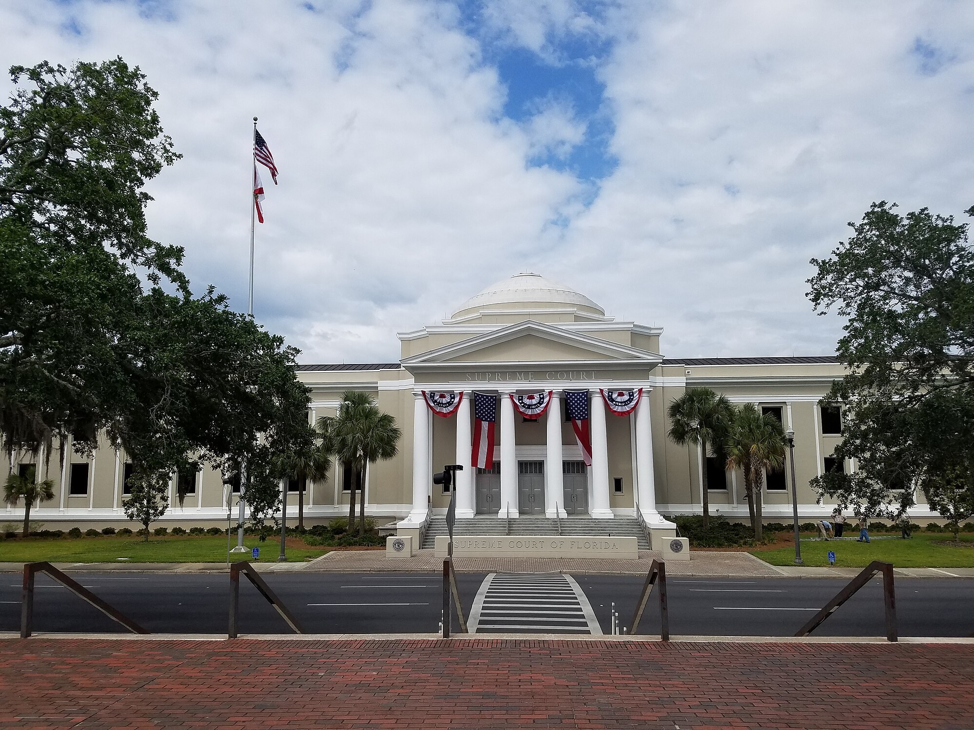 The Supreme Court of Florida building in Tallahassee, a domed classical structure with white columns hung with red white and blue bunting