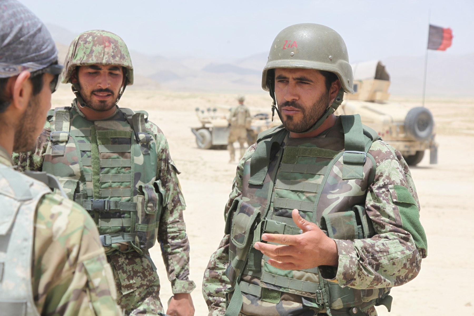Afghan National Army soldiers speak with coalition forces through an interpreter in Ghazni province, Afghanistan, in 2012