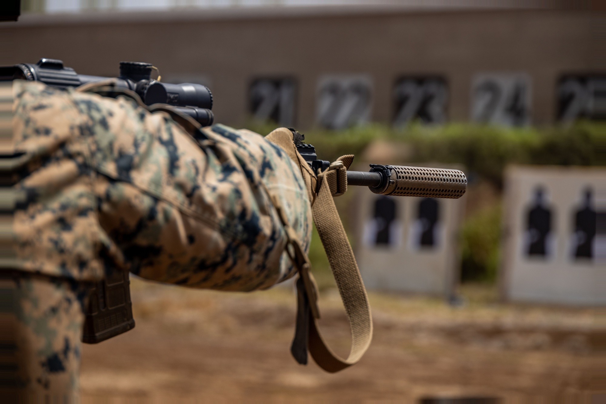 A U.S. Marine fires a suppressed M27 rifle on a range at Marine Corps Base Hawaii