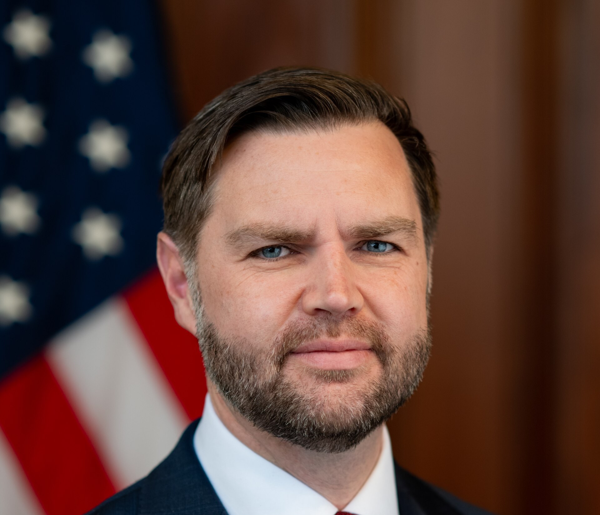 Official portrait of Vice President JD Vance in front of an American flag, March 2026