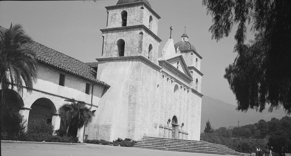 Black-and-white 1936 photograph of the Mission Santa Barbara church with its twin bell towers and front steps
