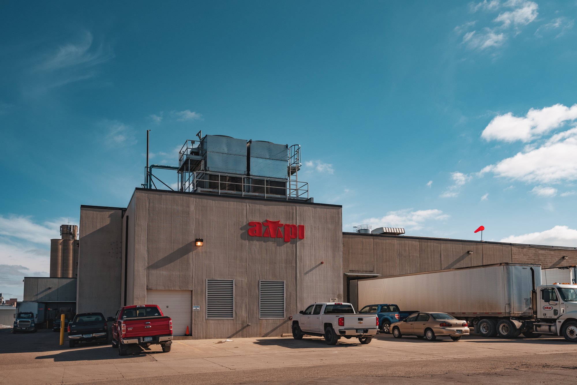 The Associated Milk Producers Inc. dairy and butter processing plant in New Ulm, Minnesota, with tanker trailers parked outside