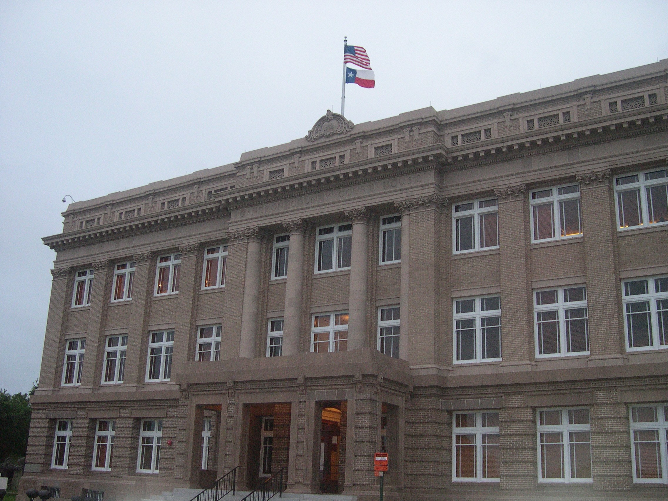 The Cameron County Court House building in Brownsville, Texas, flying the United States and Texas flags