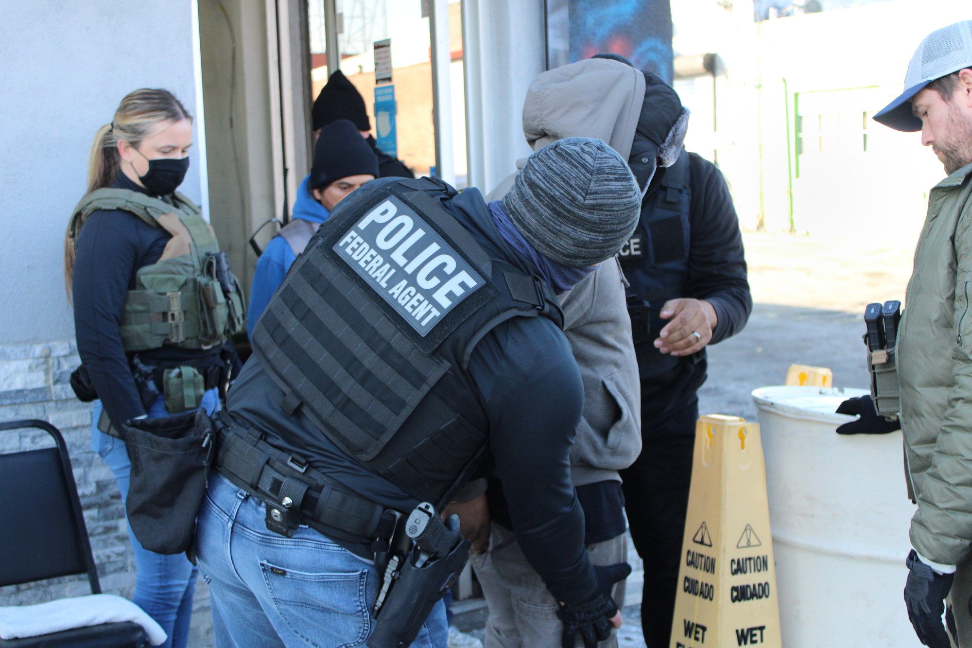 ICE Enforcement and Removal Operations officers in vests marked POLICE FEDERAL AGENT during a field operation
