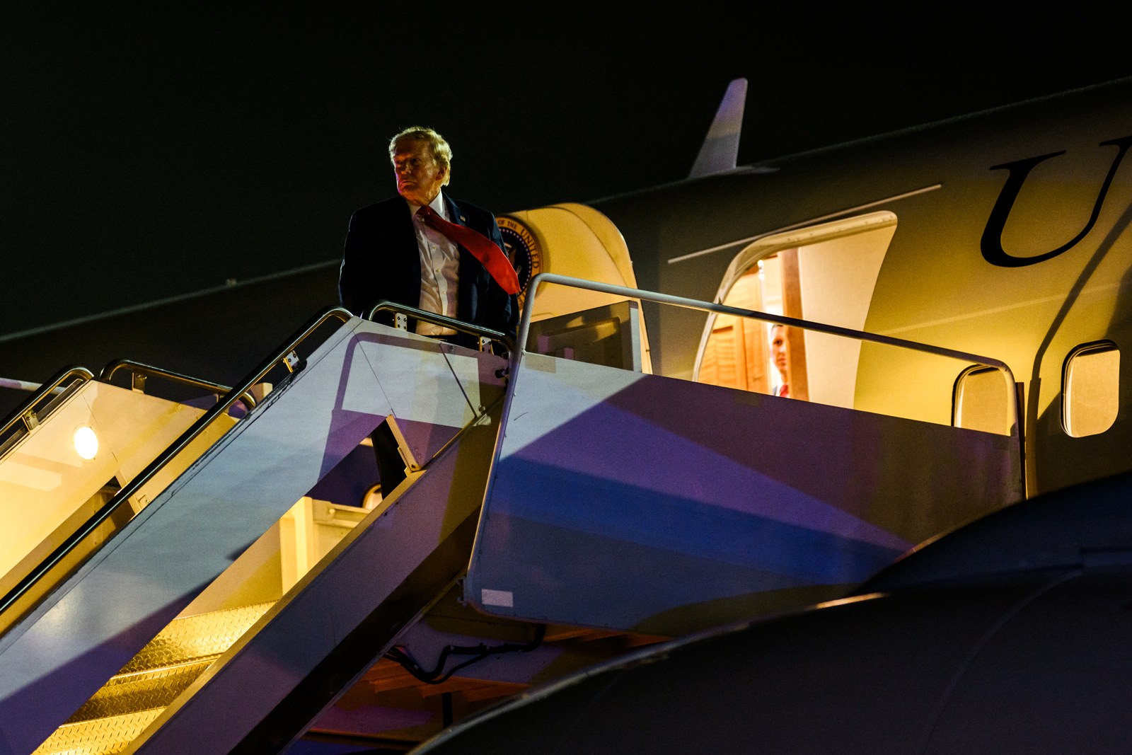 President Donald Trump boarding Air Force One at night at Myrtle Beach International Airport after a campaign rally for Sen. Darline Graham