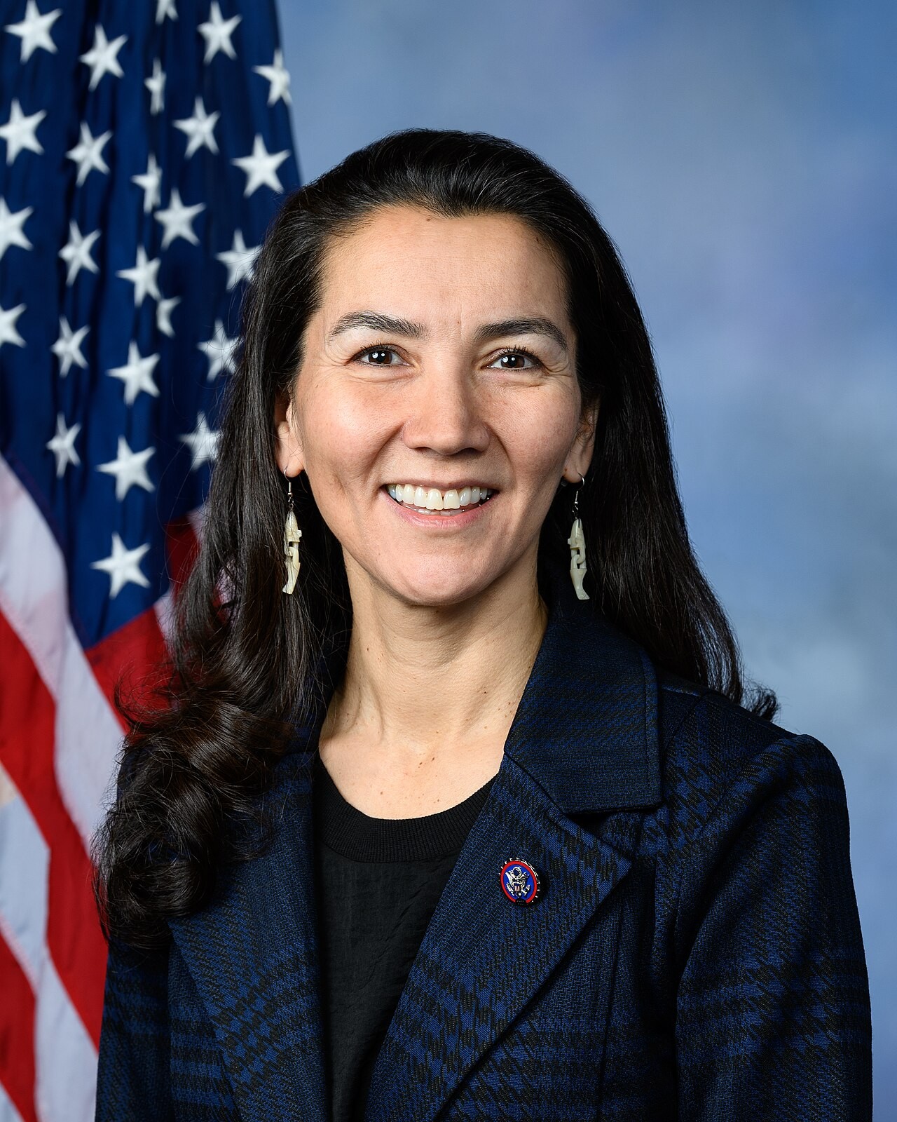 Official congressional portrait of Mary Peltola smiling in front of an American flag