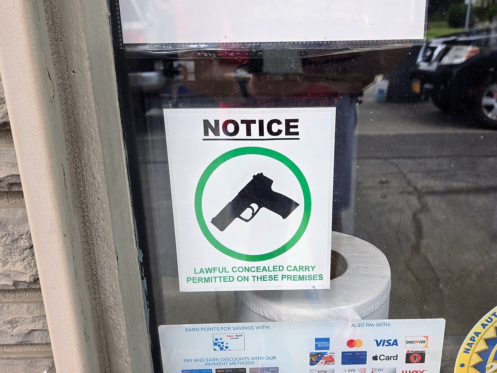 Sign on a store window reading Notice, lawful concealed carry permitted on these premises