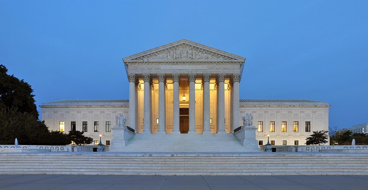 West facade of the United States Supreme Court Building in Washington, D.C., lit at dusk