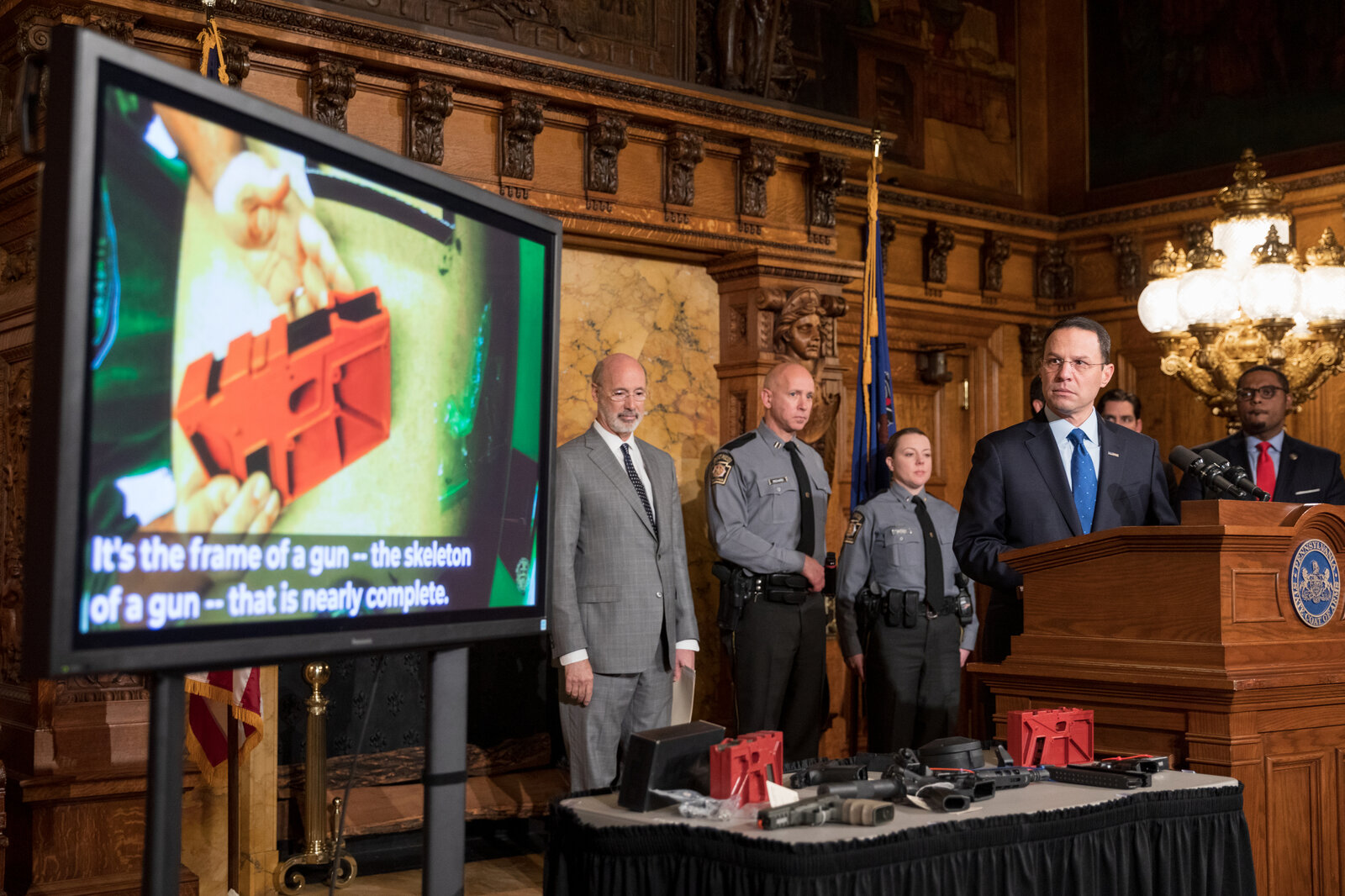 An unfinished 80% pistol frame and other firearm components displayed at a 2019 press conference on gun regulations
