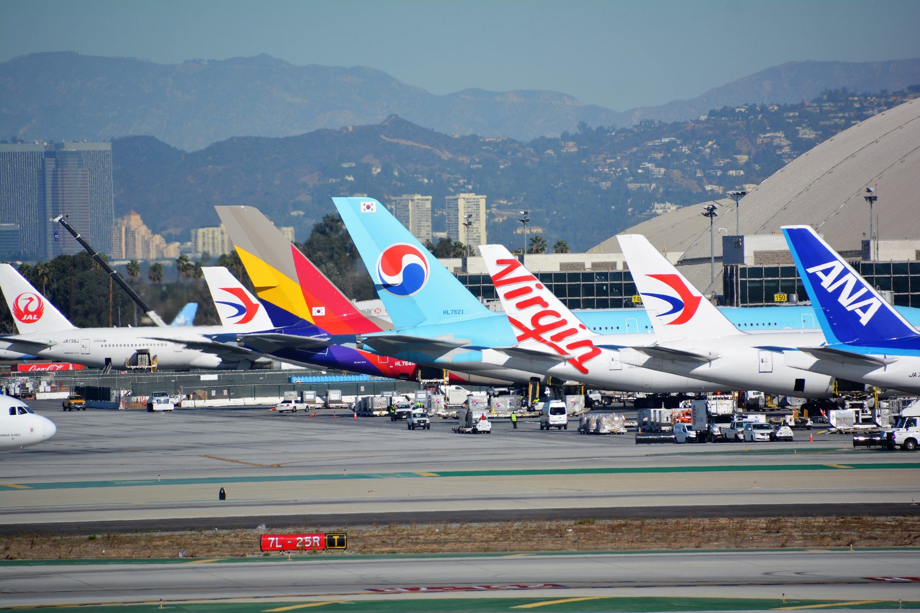 Airline tails lined up at the Tom Bradley International Terminal at Los Angeles International Airport, including a China Eastern jet