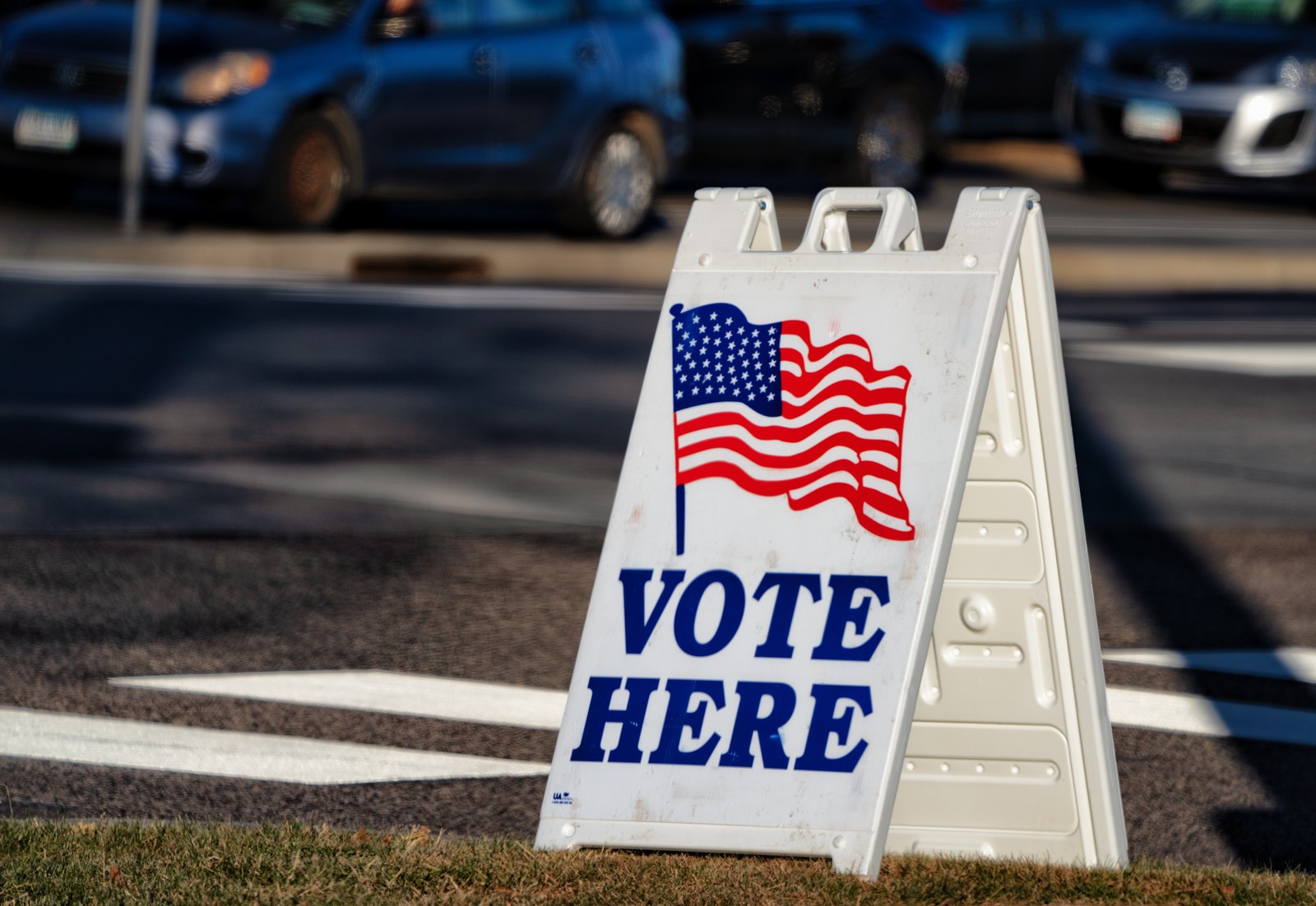 A Vote Here sign outside a polling place, illustrating the self-certification process at U.S. elections