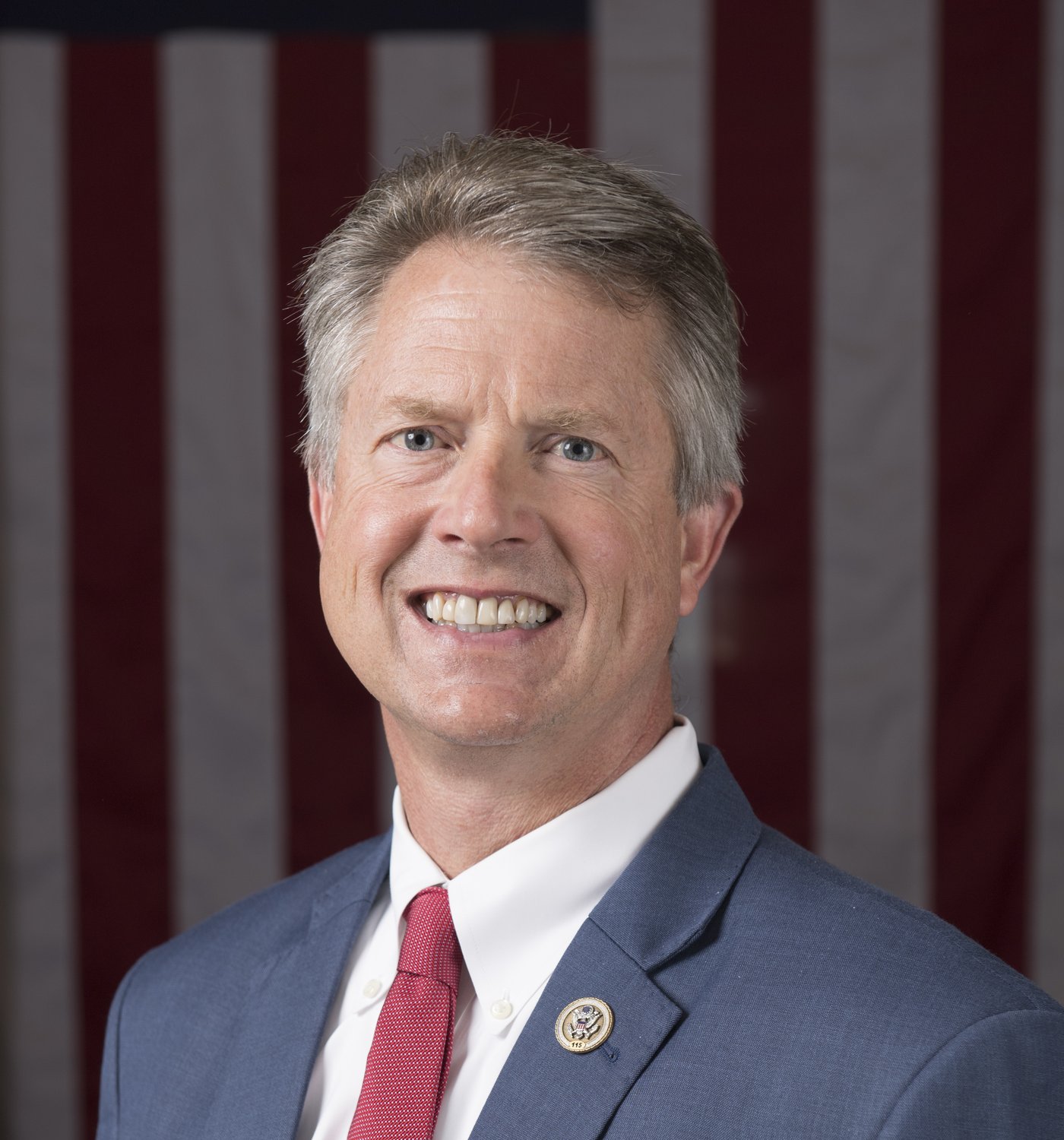 Official portrait of Roger Marshall of Kansas in front of an American flag