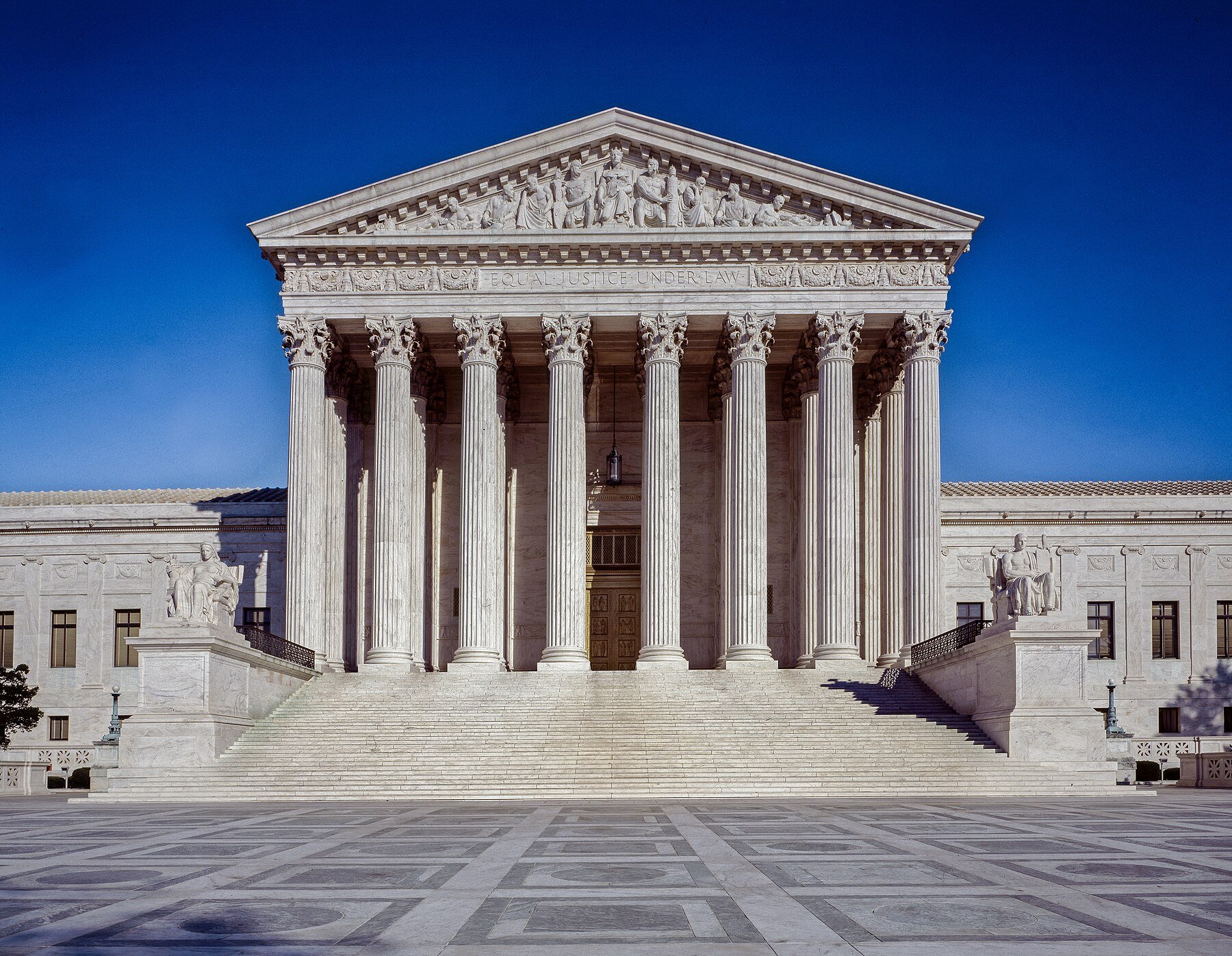 West front of the U.S. Supreme Court Building in Washington, D.C., under a clear blue sky