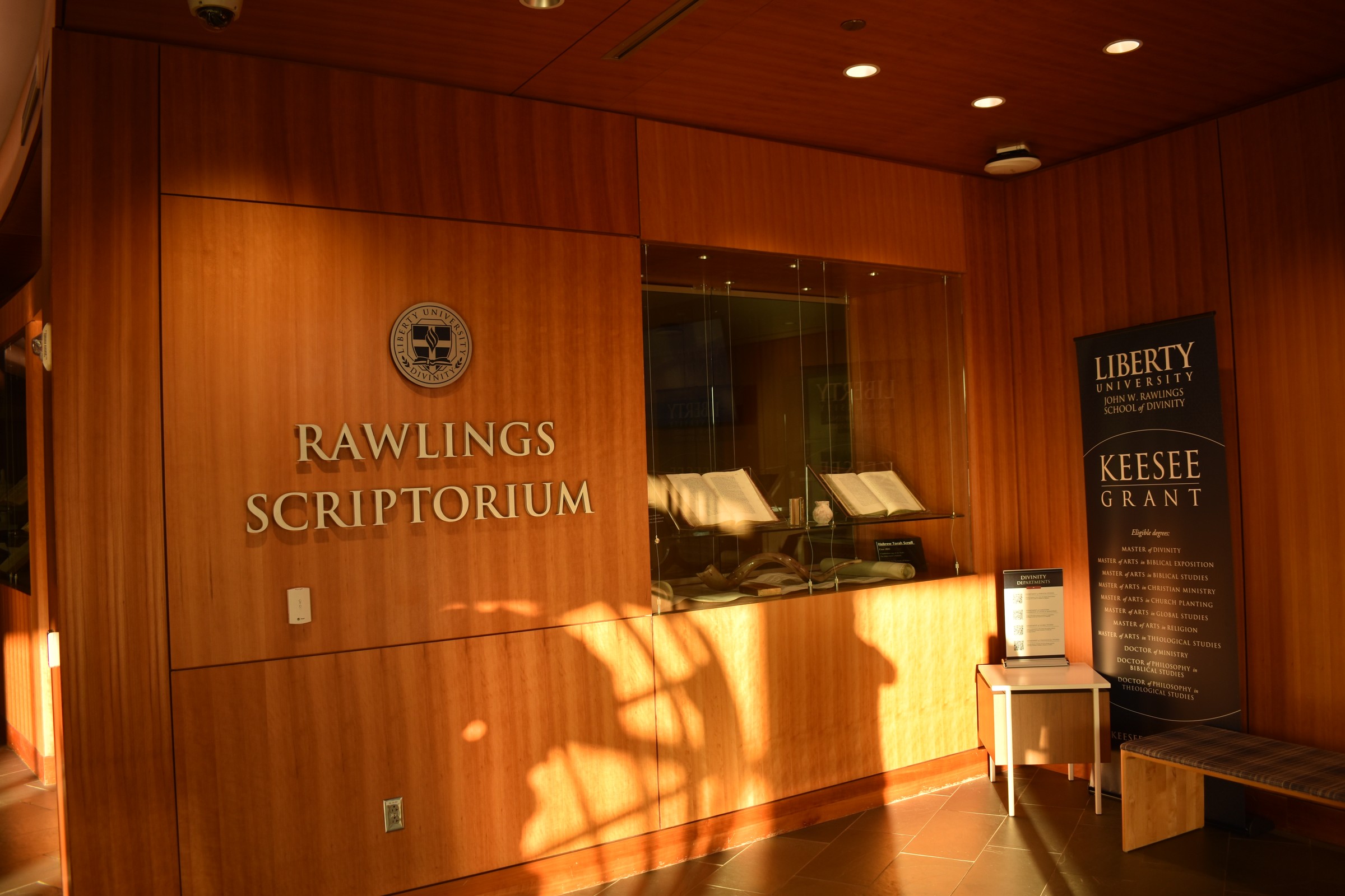 The Rawlings Scriptorium at Liberty University's John W. Rawlings School of Divinity in Lynchburg, Virginia, with a banner listing divinity degree programs