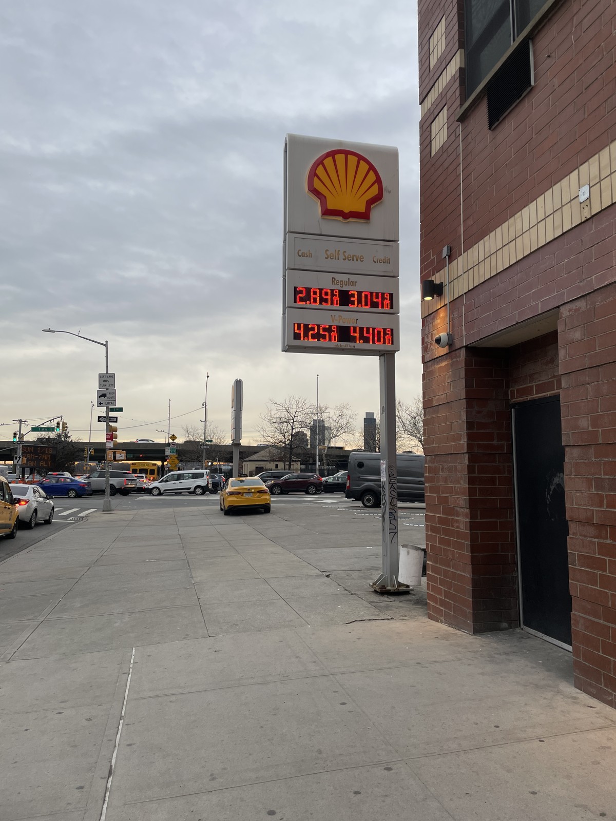 A Shell station price board at 1855 First Avenue in Manhattan on January 14, 2026, showing regular gasoline at $2.89 cash and $3.04 credit