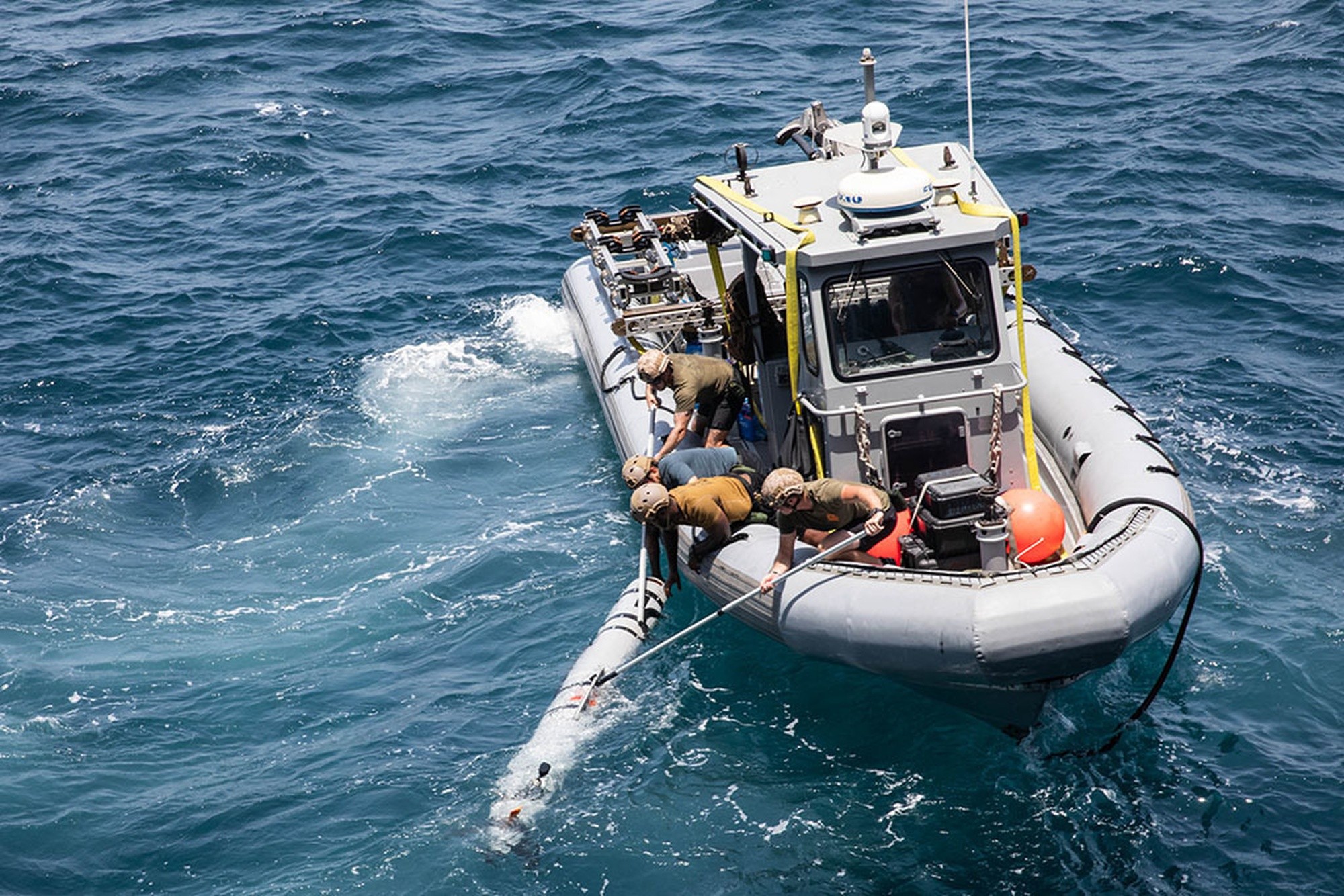 U.S. Navy sailors assigned to Commander, Task Force 52 recover a Mark 18 Mod 2 unmanned underwater vehicle from a rigid-hull inflatable boat during mine countermeasures training in the Arabian Gulf