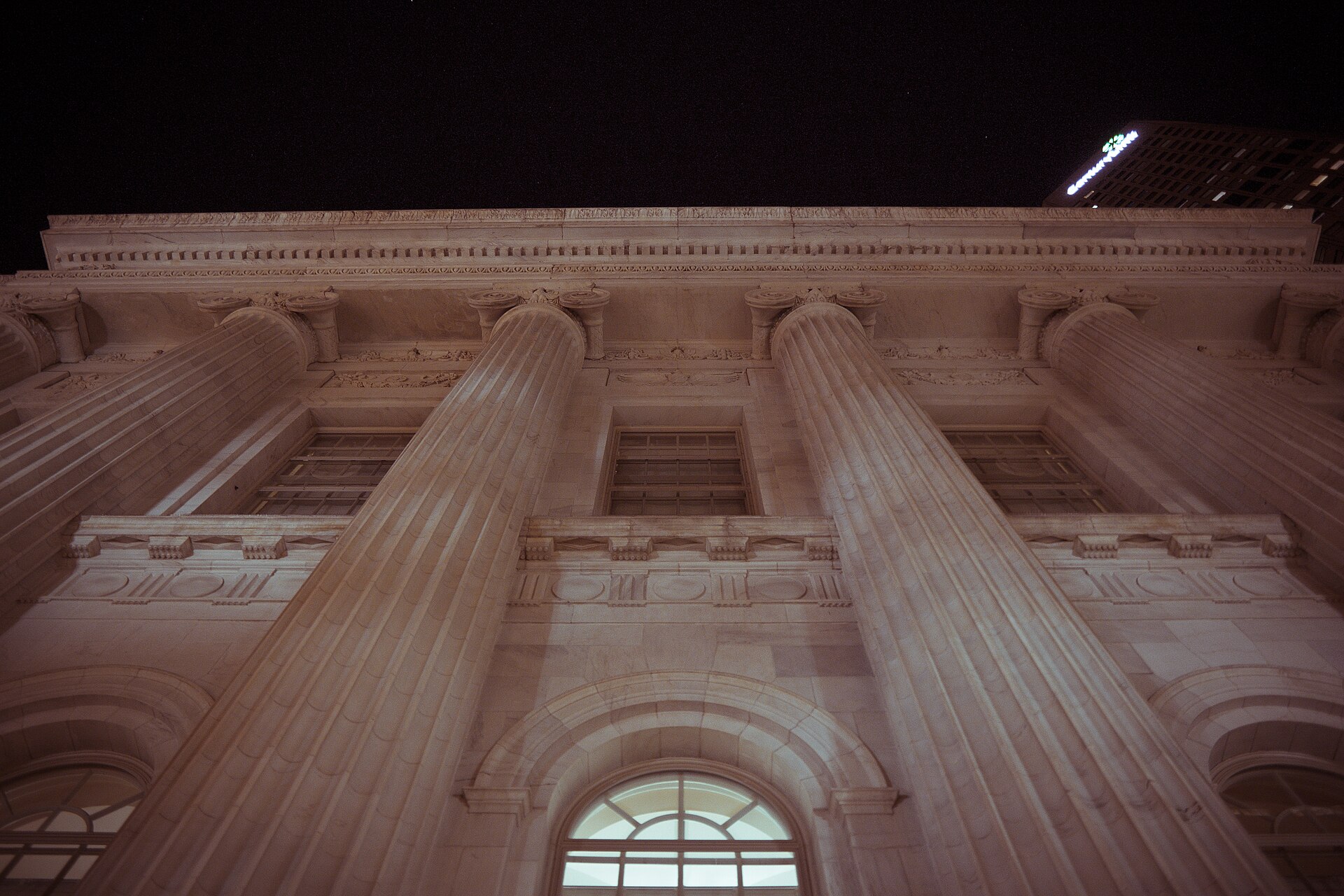 Looking up at the marble columns of the Byron White United States Courthouse in Denver at night