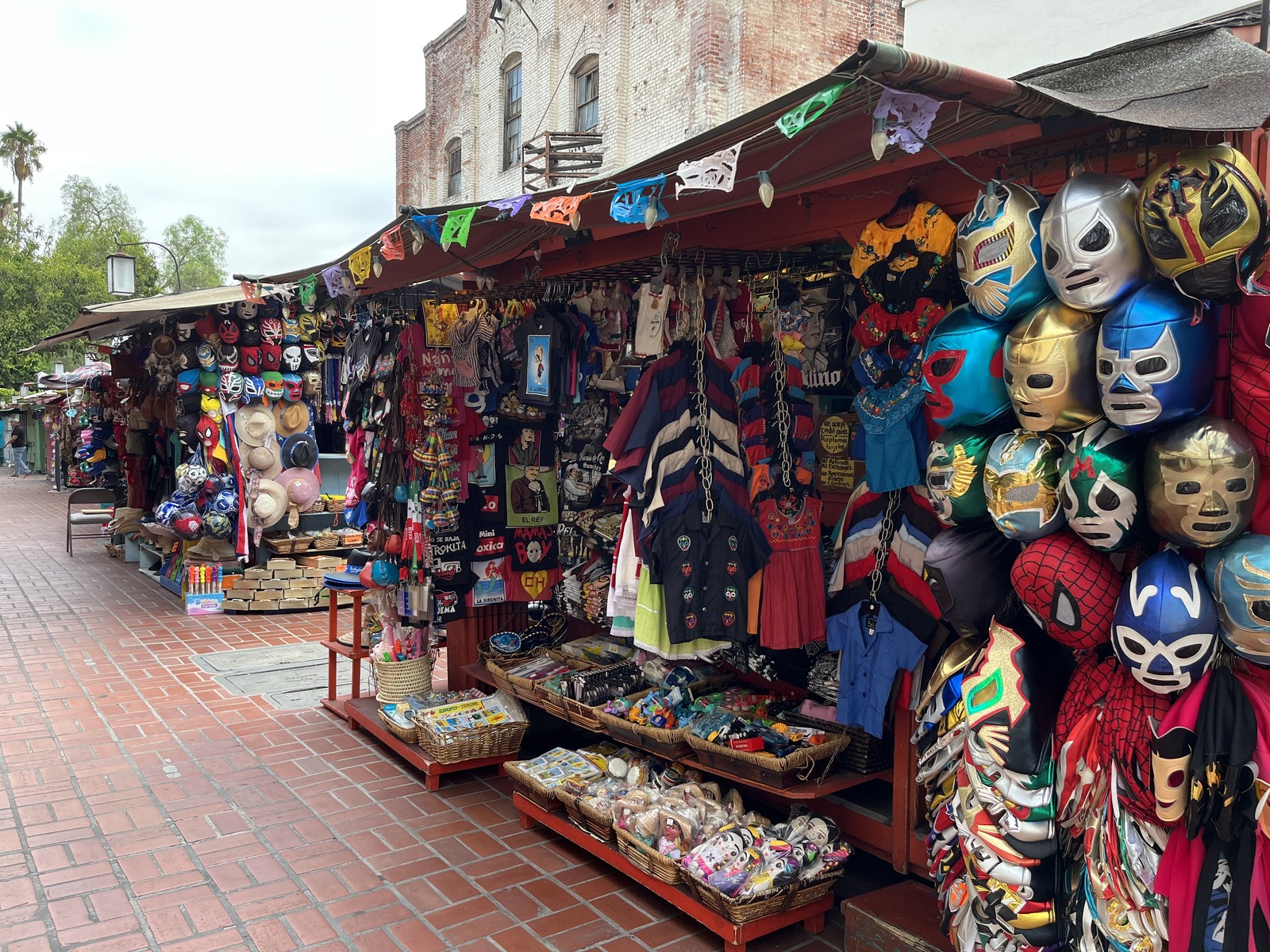 Merchant stalls selling masks, shirts and crafts along Olvera Street in downtown Los Angeles