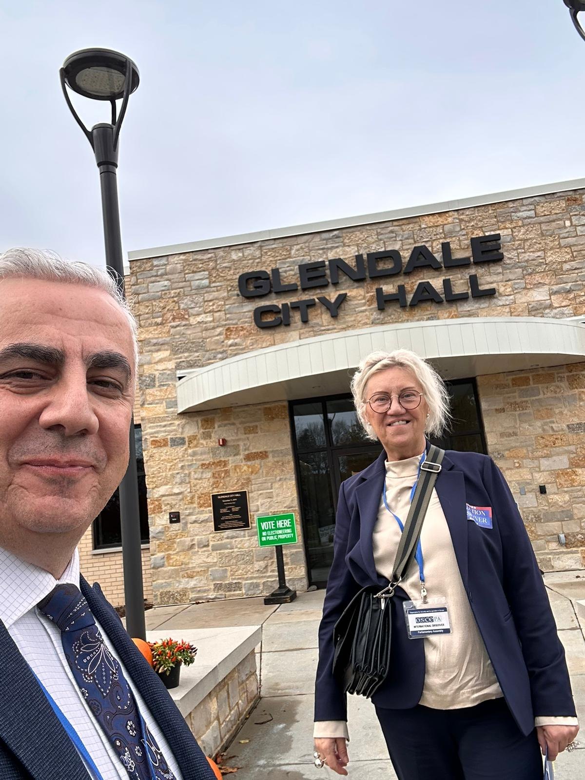 OSCE election observers wearing credentials outside Glendale City Hall in Wisconsin on November 5, 2024