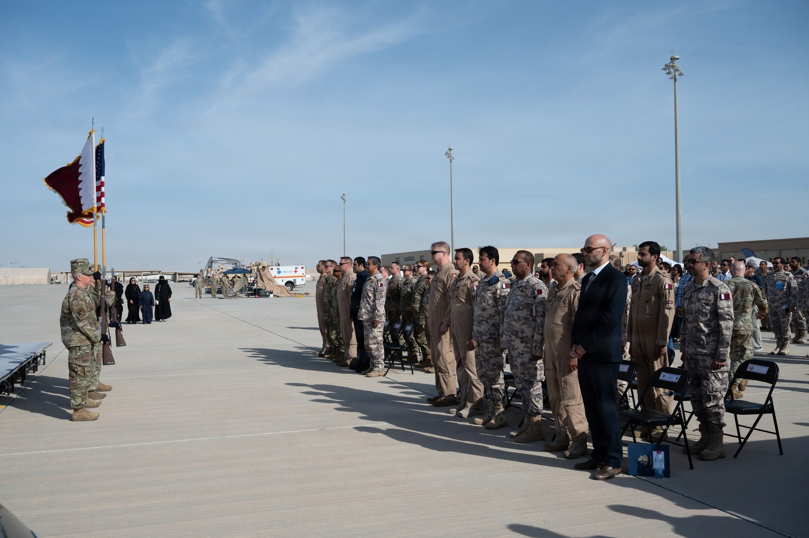 Qatari Emiri Air Force and U.S. Air Force personnel standing in formation during a Partnership Day ceremony at Al Udeid Air Base, Qatar
