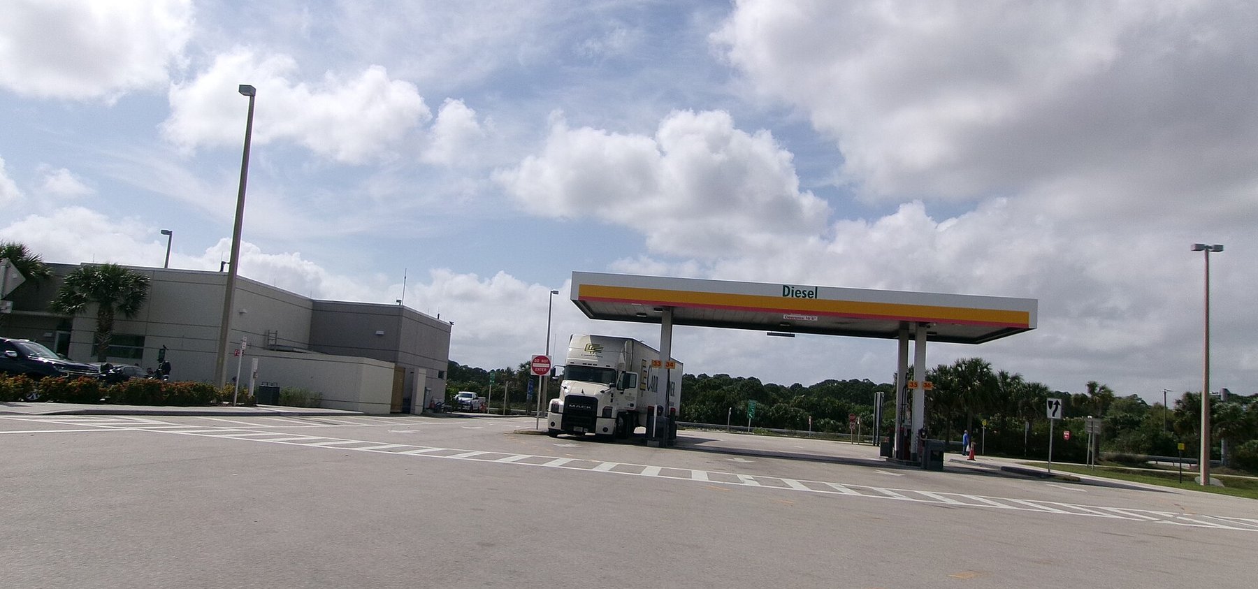 A tractor-trailer parked at the diesel pump canopy of the Fort Pierce Service Plaza on Florida's Turnpike