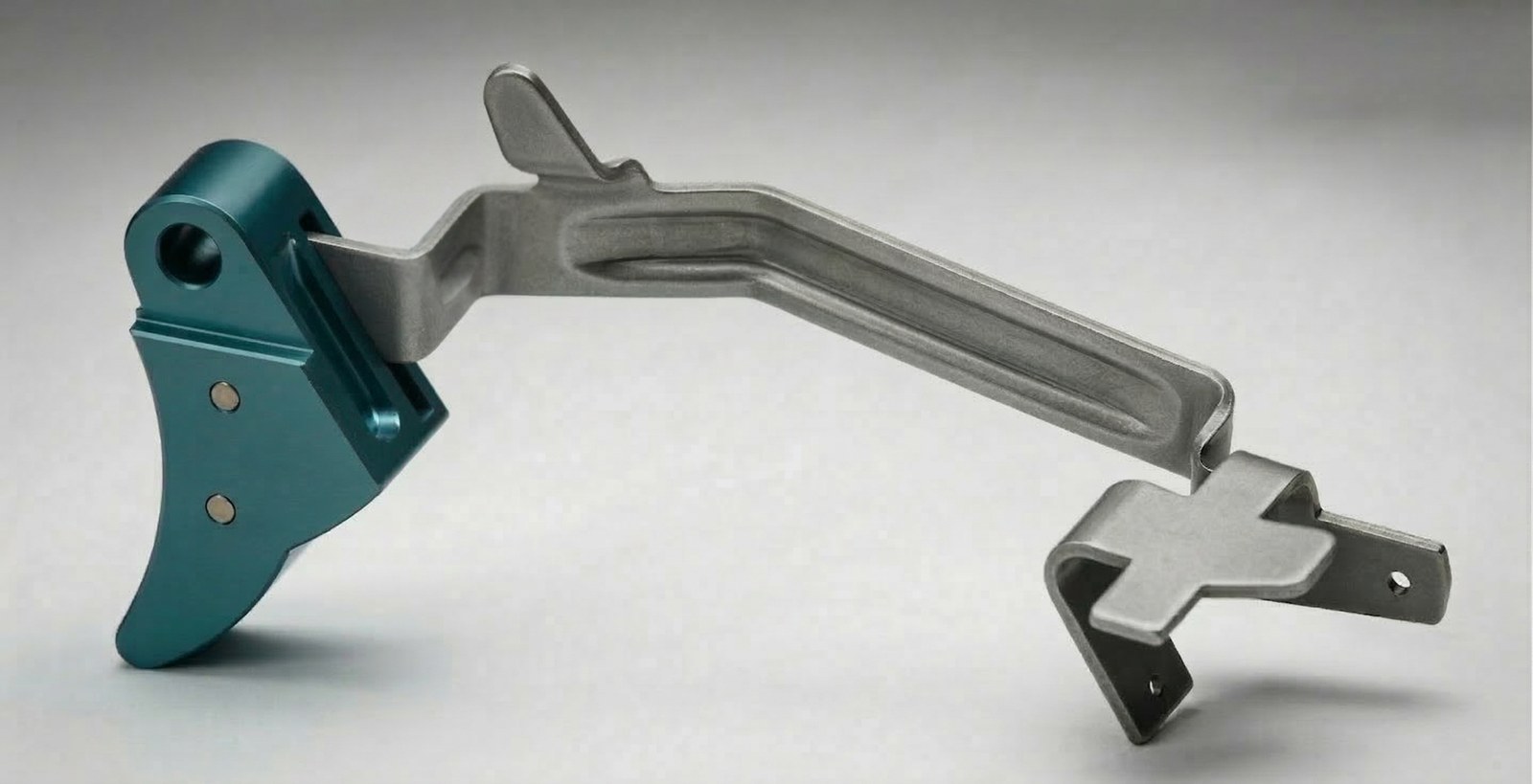 Illustration of a Glock-style trigger bar showing the cross-shaped cruciform sear at the rear end