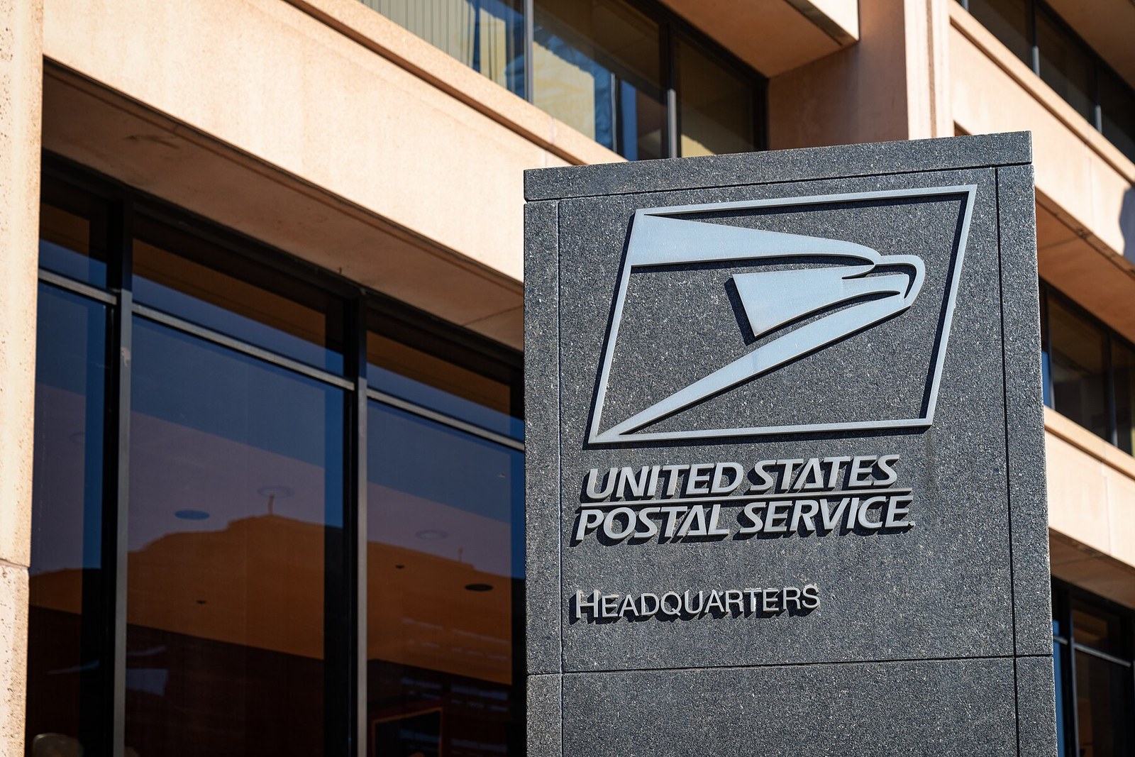 Granite sign reading United States Postal Service Headquarters outside the USPS headquarters building in Washington, D.C.