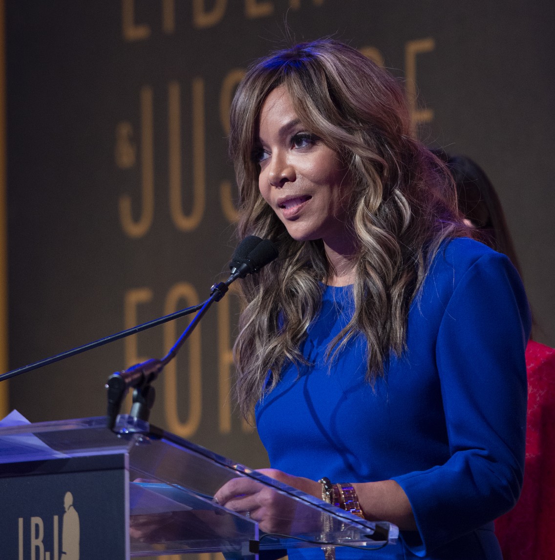 Sunny Hostin speaking at a podium
