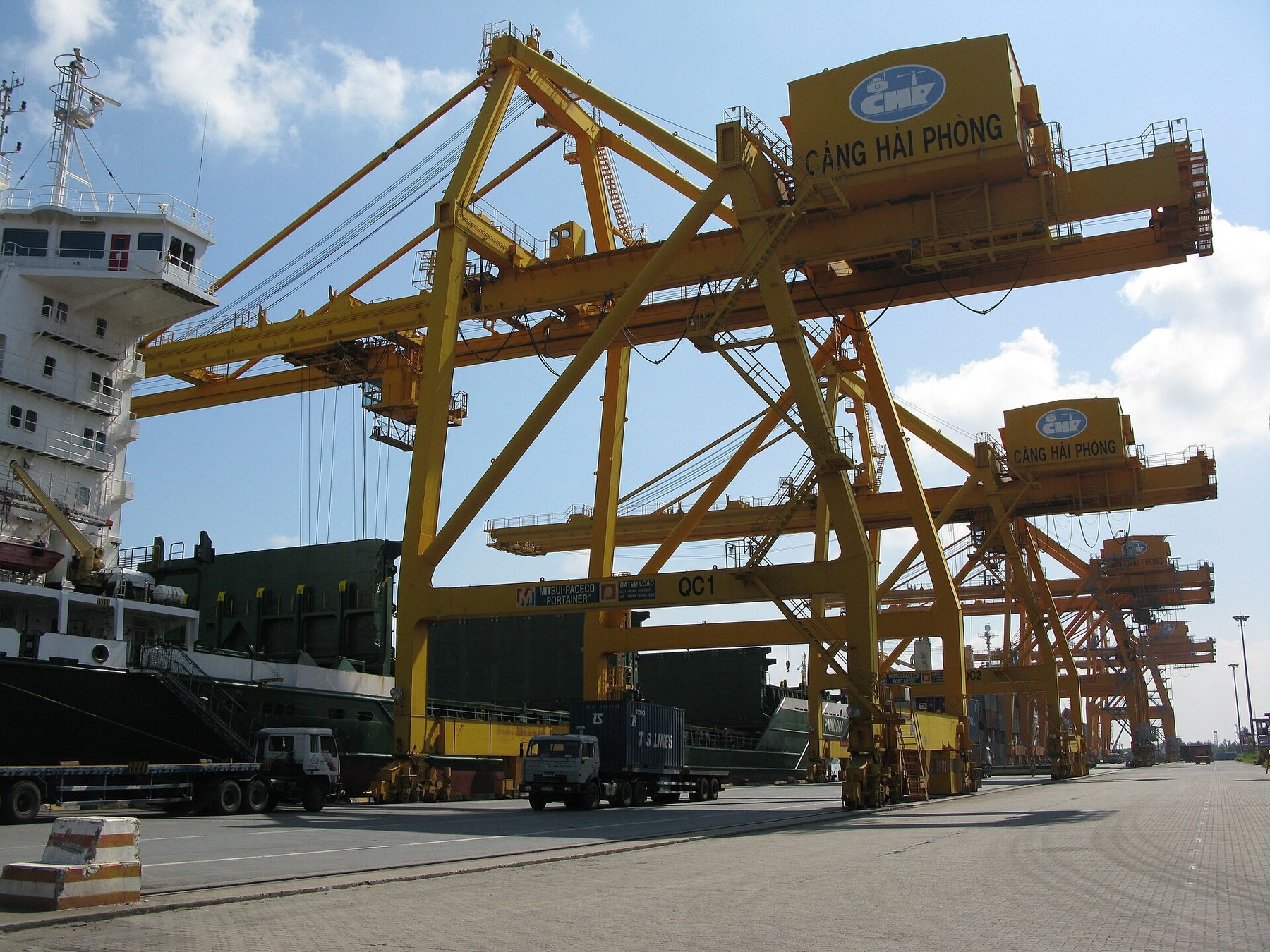 Yellow ship-to-shore container cranes at the Chua Ve terminal, Port of Hai Phong, Vietnam
