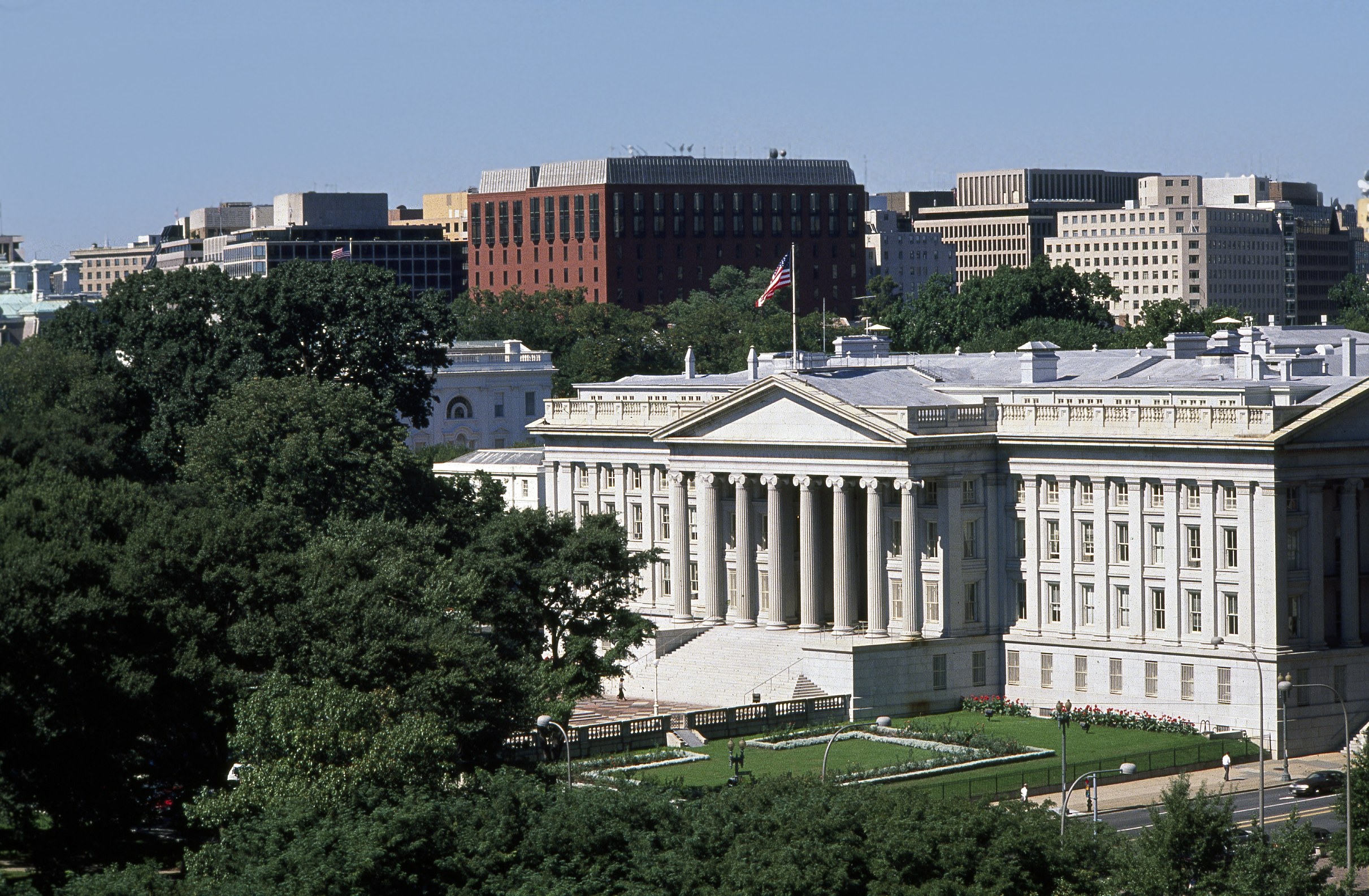 Aerial view of the U.S. Treasury Building in Washington, D.C., with the Treasury flag flying