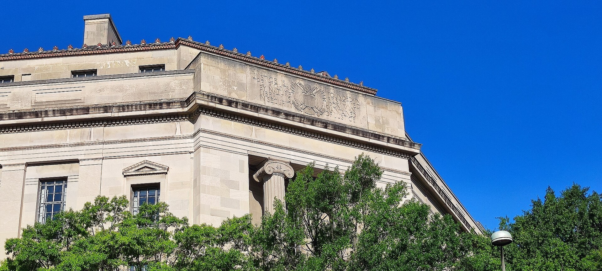 Corner of the Robert F. Kennedy Department of Justice Building in Washington, D.C., with its carved Justice inscription