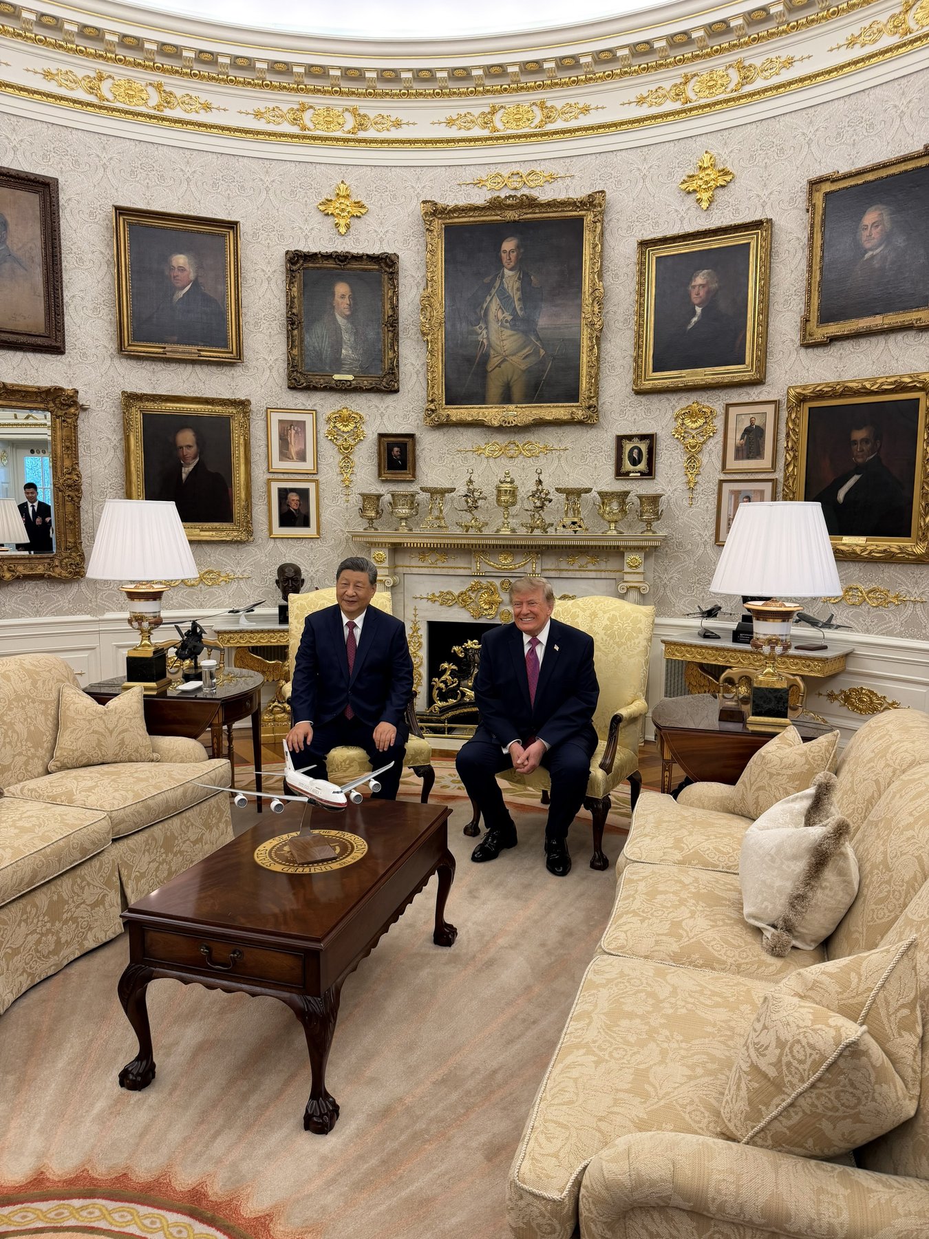 President Donald Trump and Chinese President Xi Jinping seated side by side in the Oval Office in front of the fireplace