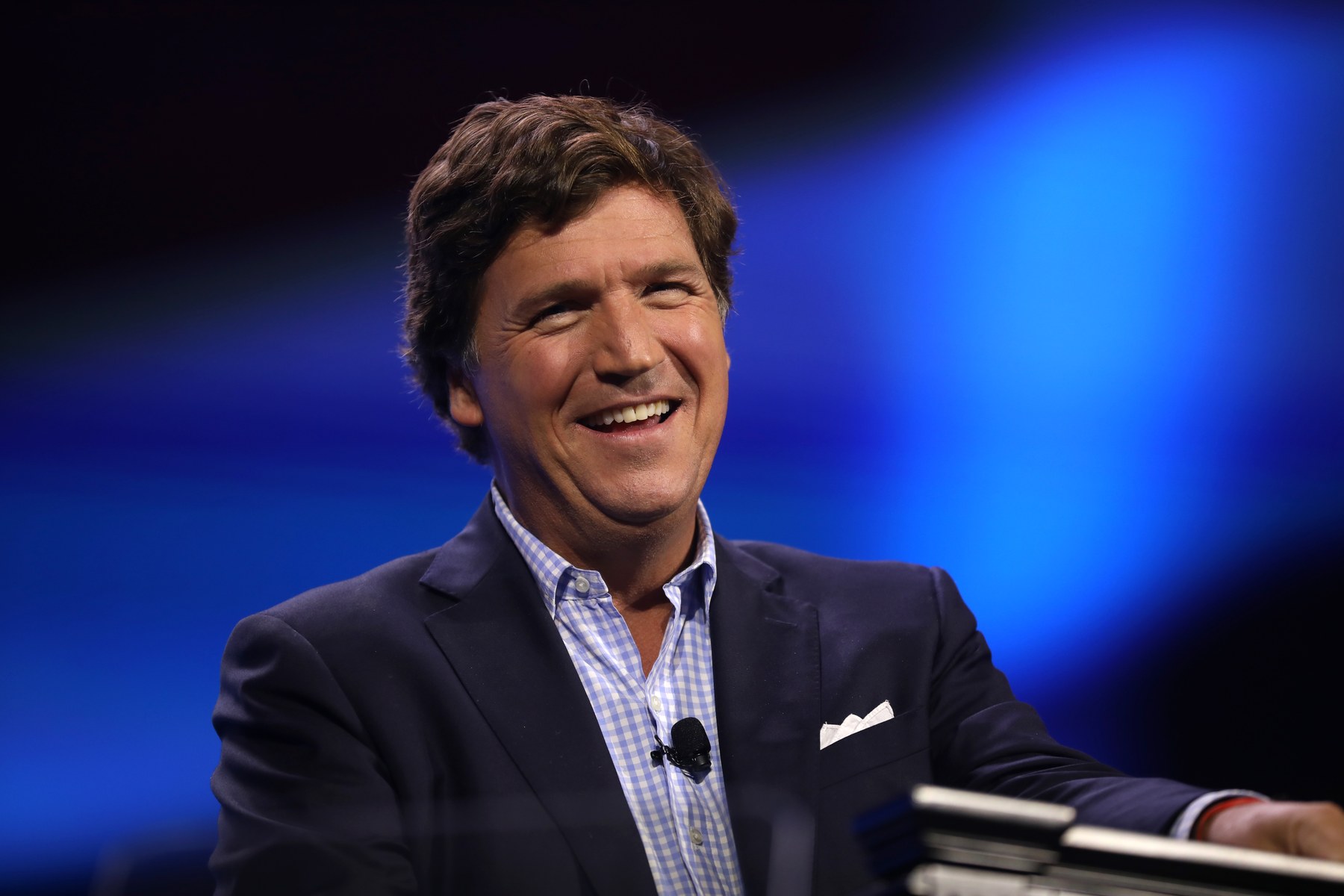 Tucker Carlson speaking on stage