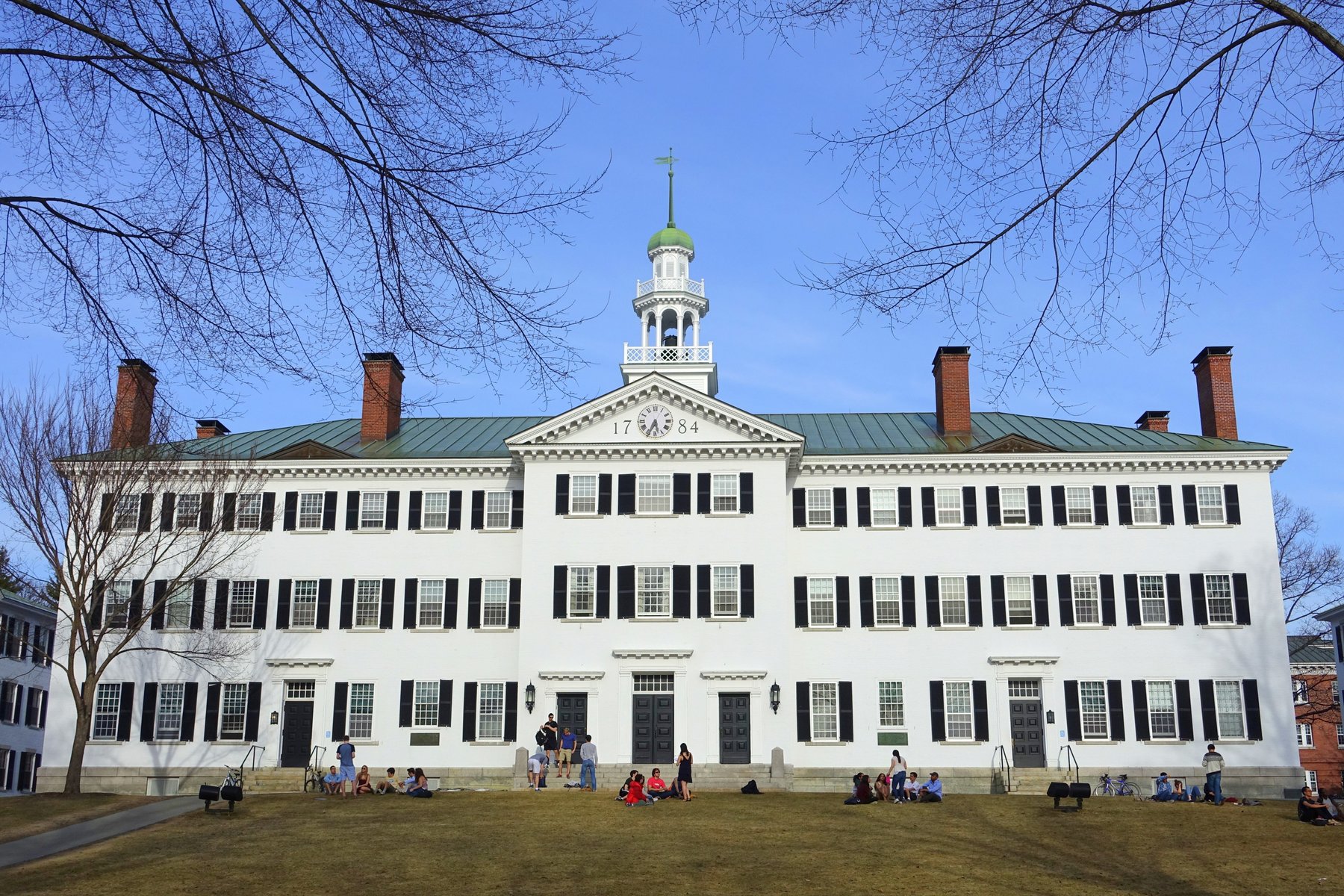Dartmouth Hall, a white three-story colonial building with black shutters and a cupola, at Dartmouth College in Hanover, New Hampshire
