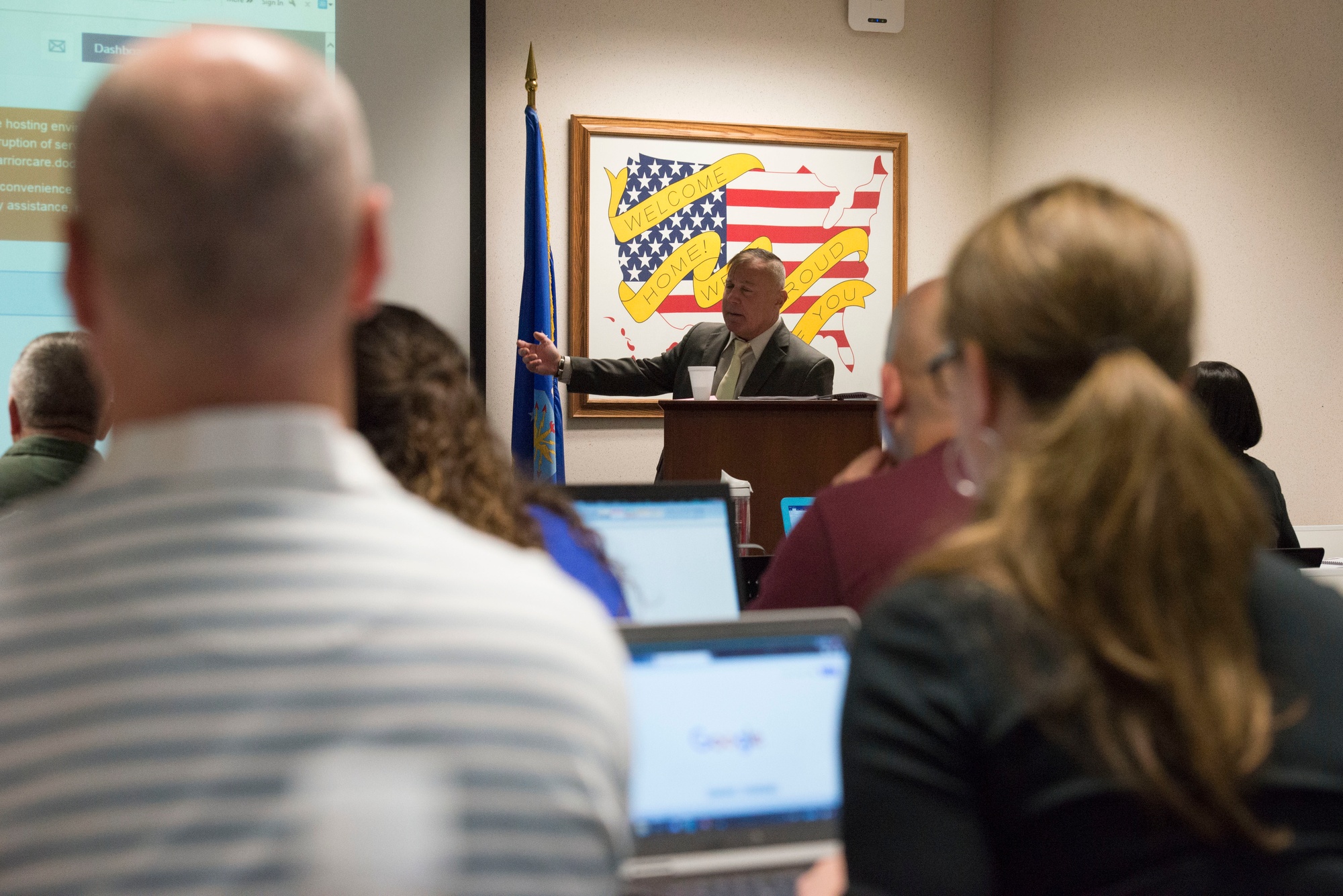 Service members and a veterans affairs benefits advisor at a Transition Assistance Program briefing