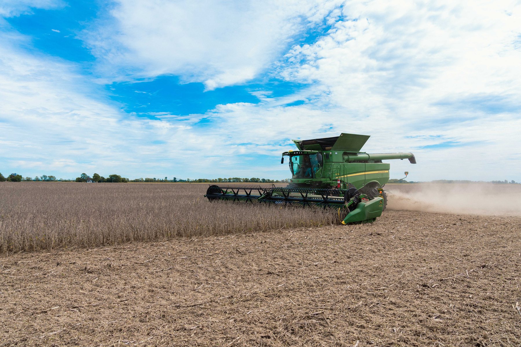 A combine harvests soybeans in a field in Brownsburg, Indiana