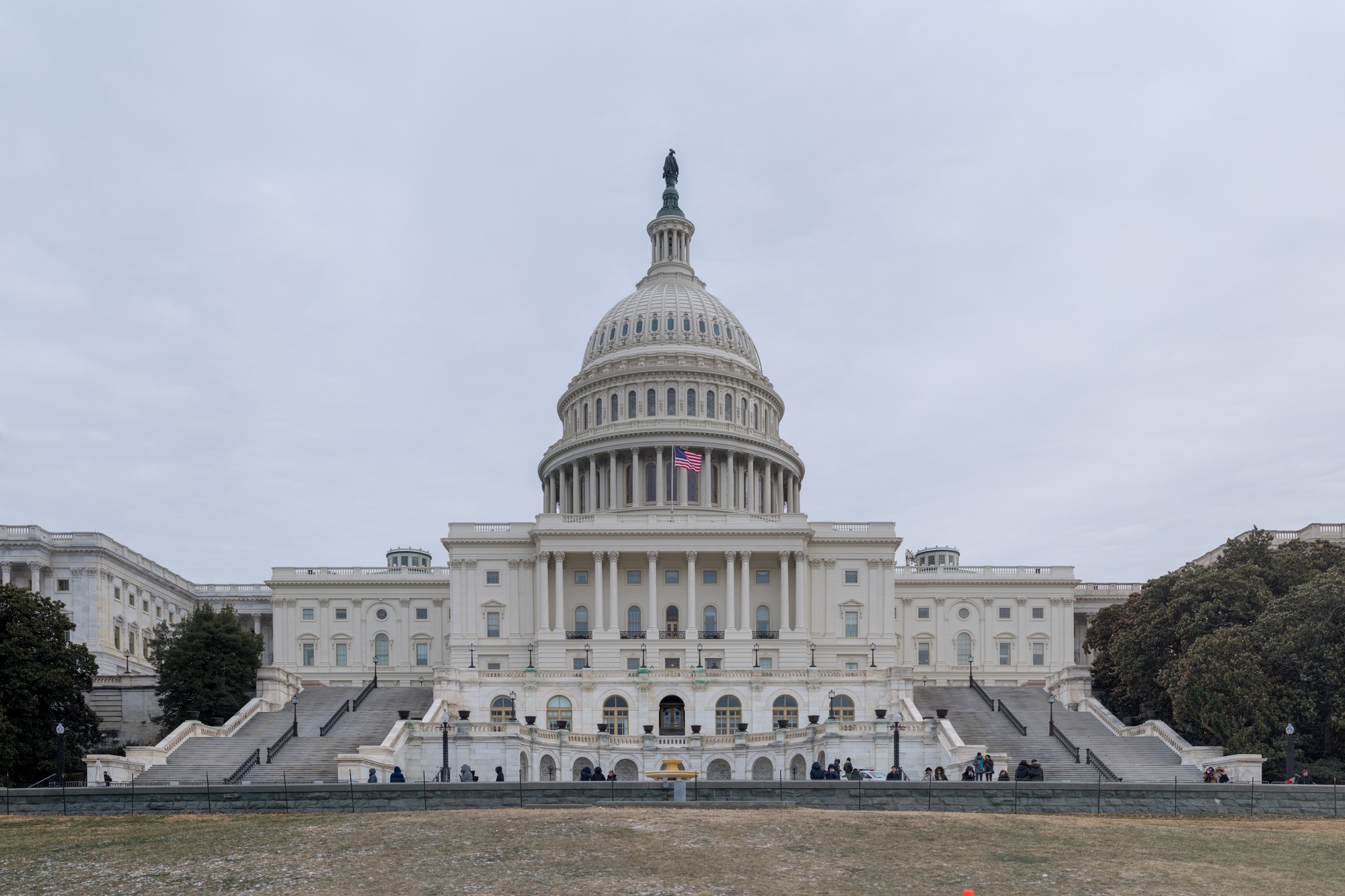 The United States Capitol building, west front, under an overcast sky
