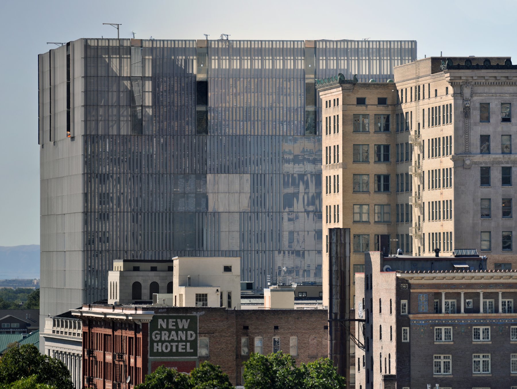 The modern glass-sided Orrin G. Hatch United States Courthouse in downtown Salt Lake City behind older brick buildings