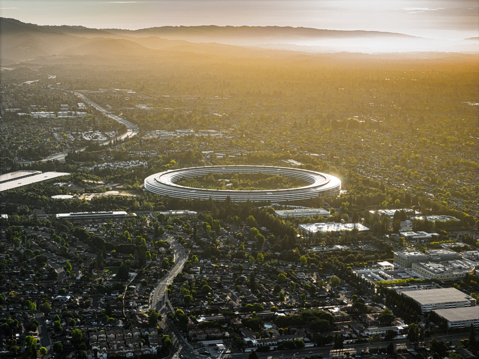 Aerial view of Apple Park, Apple's headquarters in Cupertino, California, at sunrise