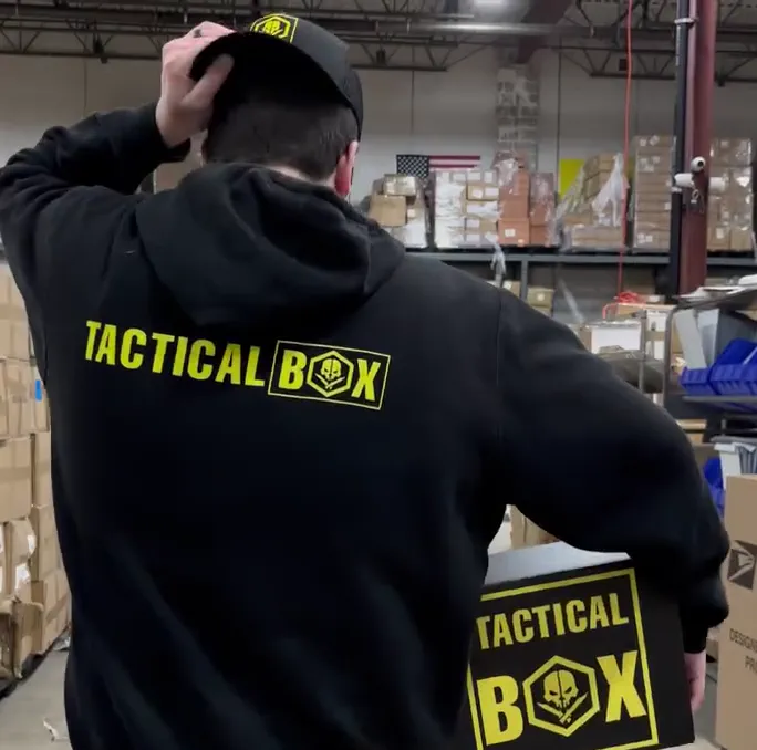 TacticalBox and gear laid out on a table with the WELCOME100 code shown