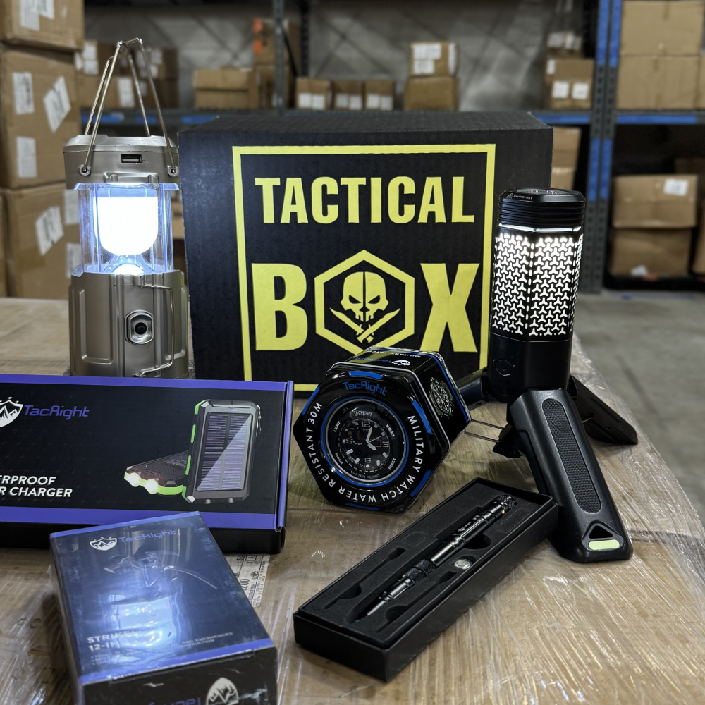 Premium TacticalBox gear unboxed and lit — glowing camping lantern, waterproof solar charger, military watch, flashlight