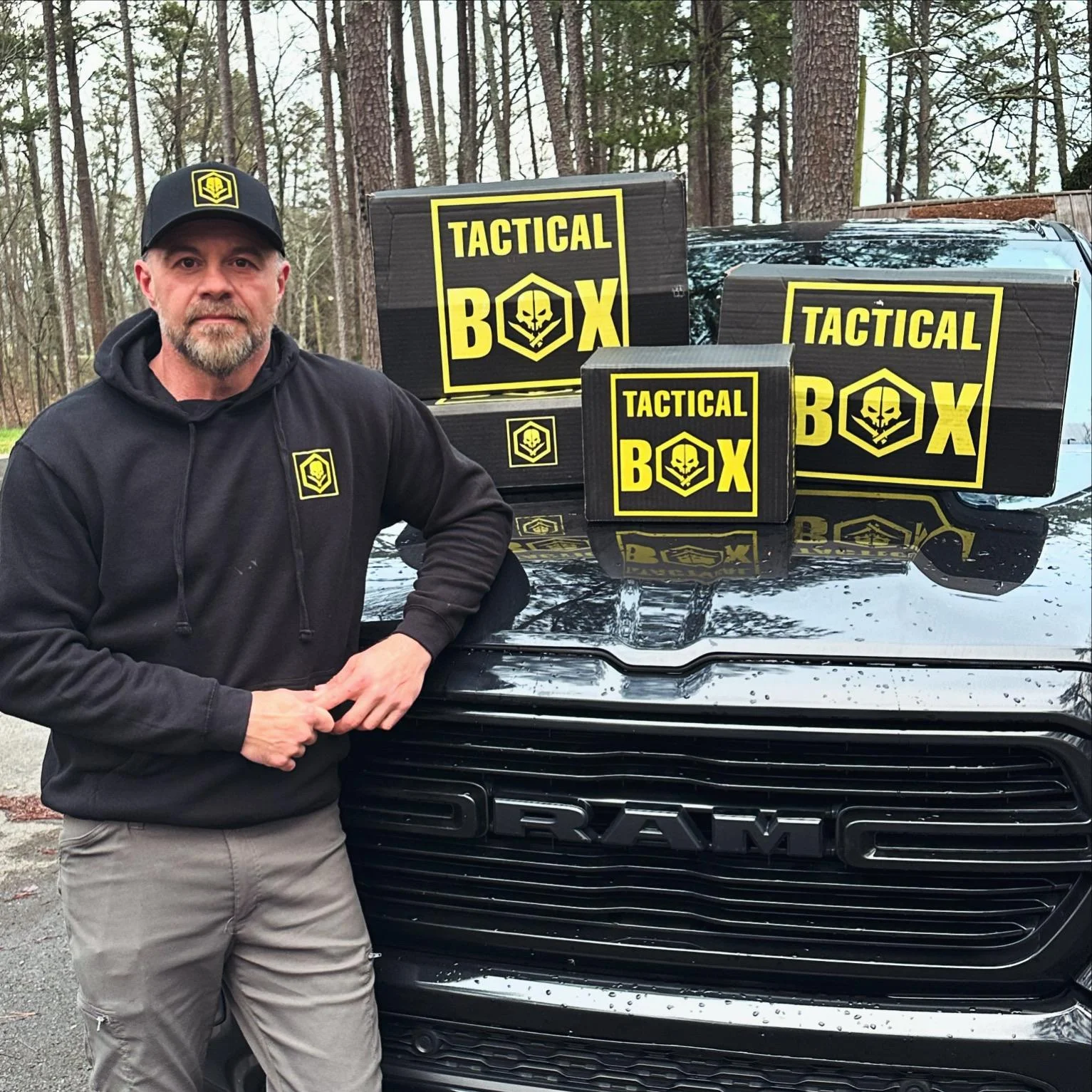 TacticalBox curator — bearded man in branded gear next to truck with TacticalBox shipments