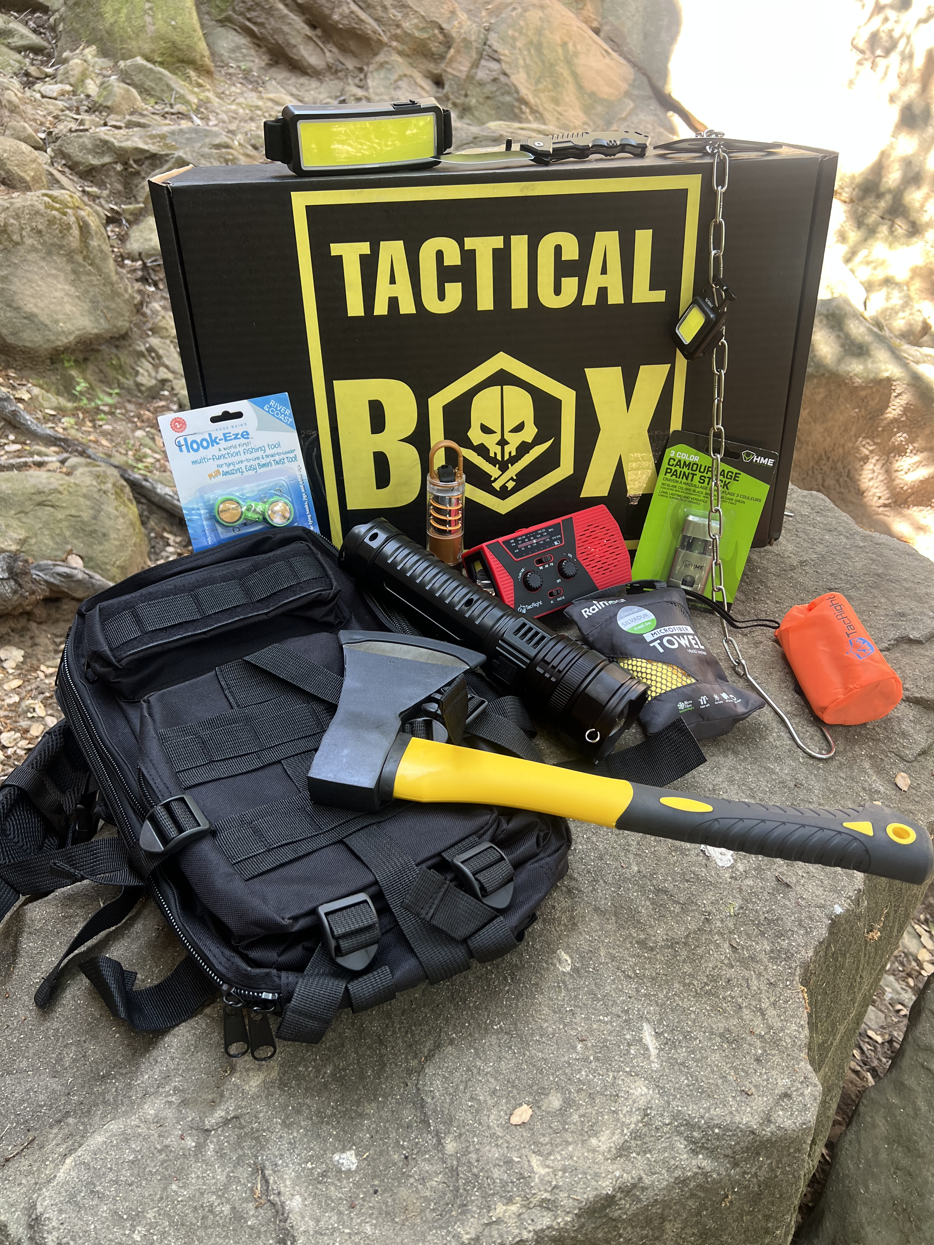 Travis's TacticalBox — gear spread with axe on West Texas rocks