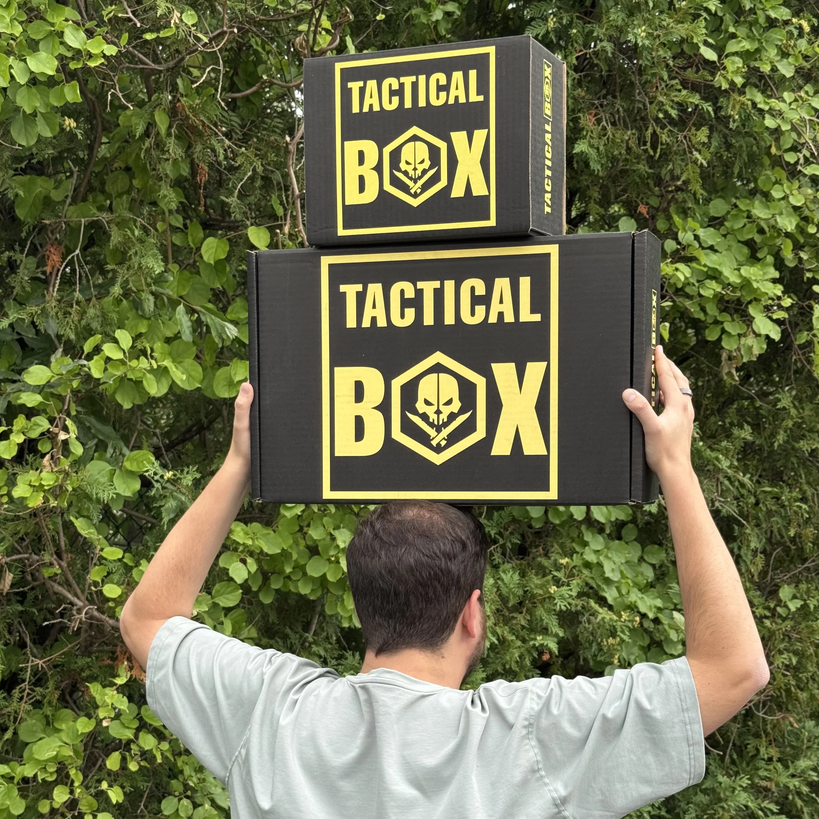 A member holding a small TacticalBox next to a much larger TacticalBox for size comparison
