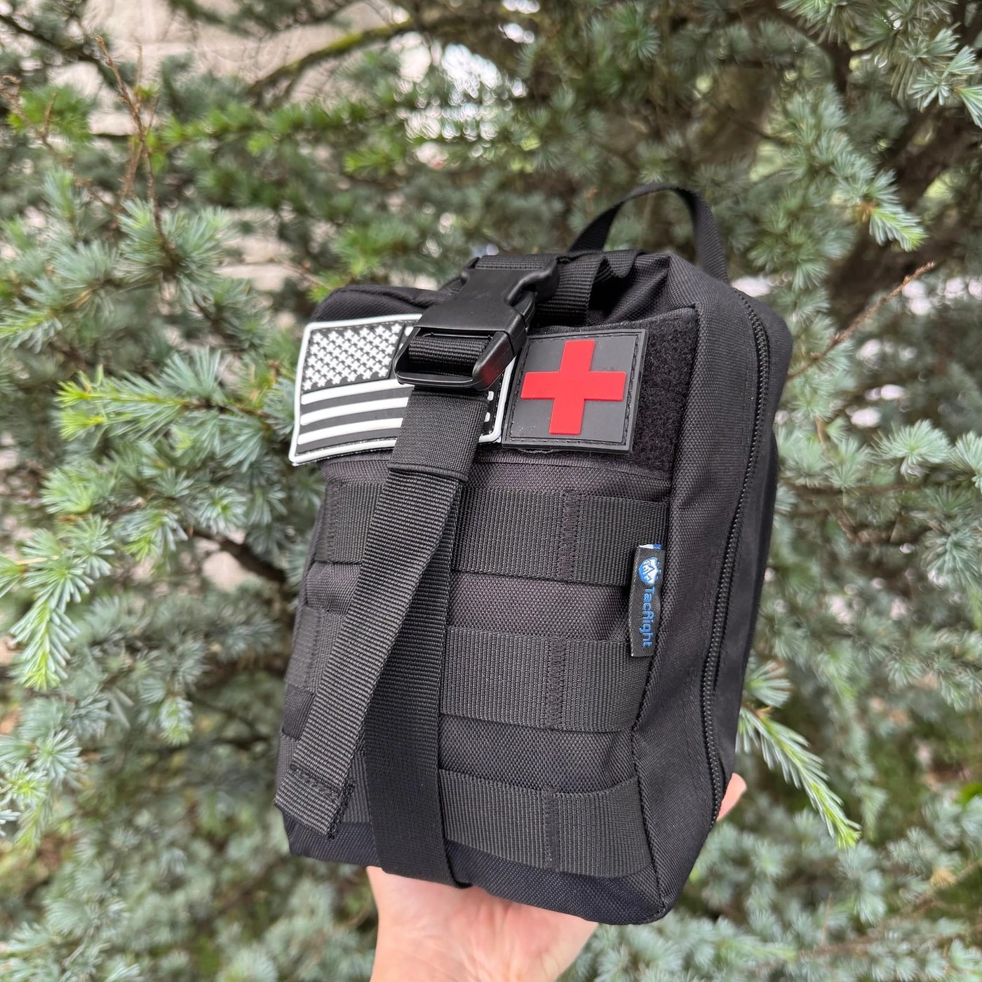The Trauma First Aid Kit held up to show its compact size