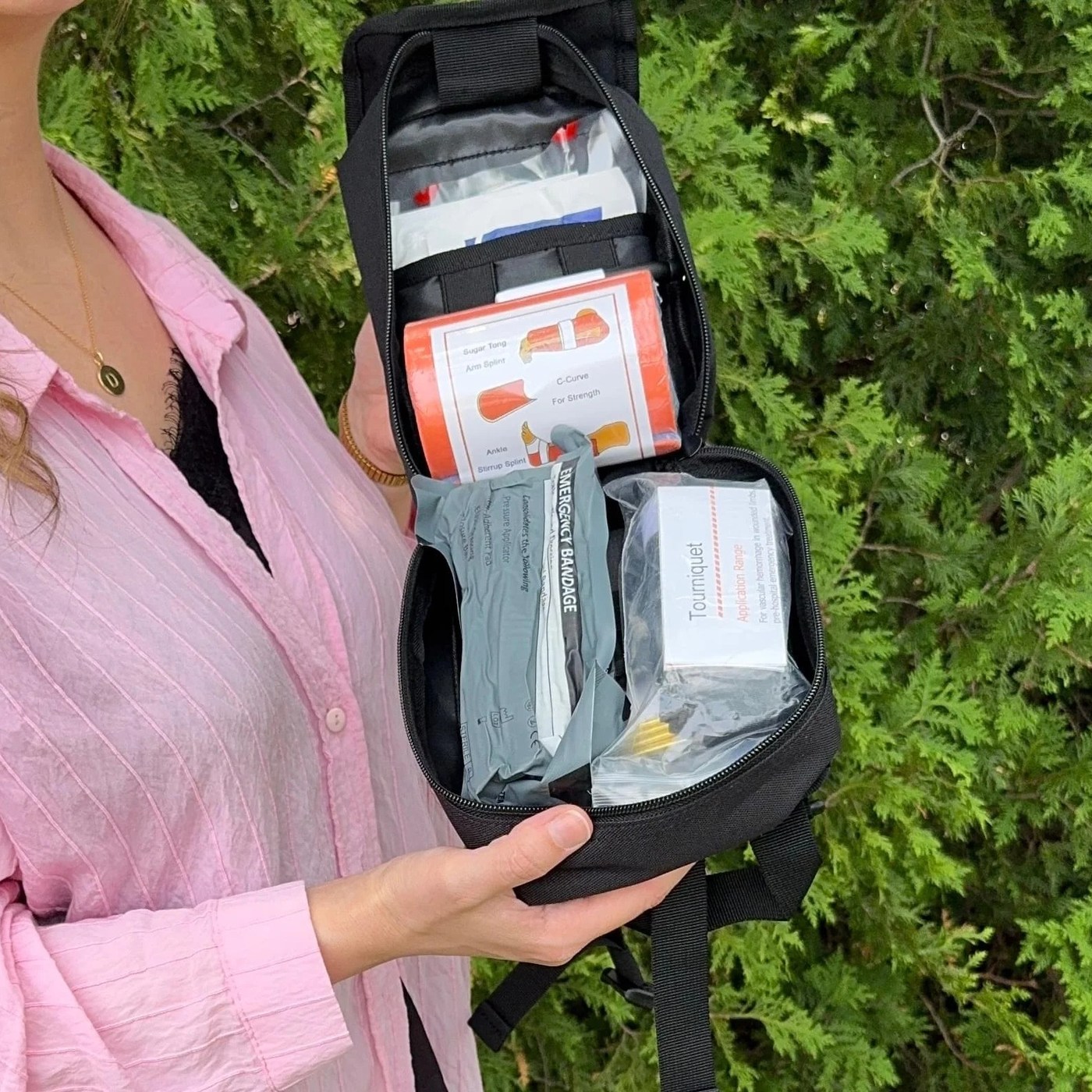 The Trauma First Aid Kit held open outdoors, supplies visible in its elastic loop panels